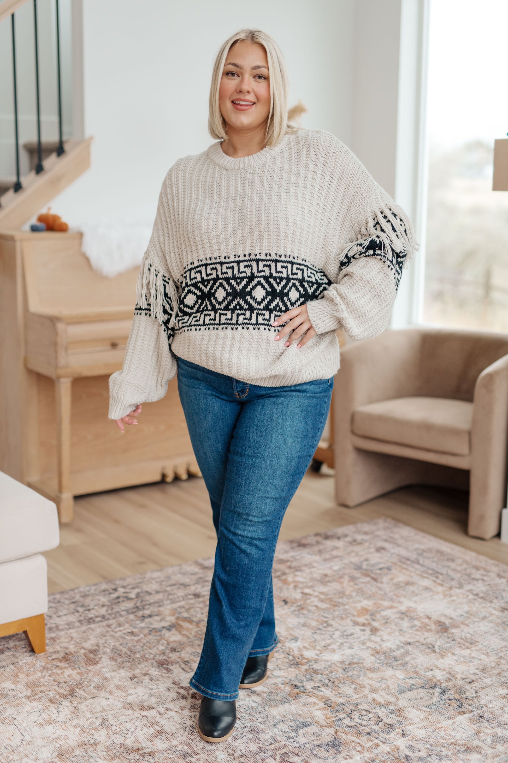 Woman's mid-weight sweater with a geometric print, featuring fringe trim, a ribbed crew neckline, long balloon sleeves with drop shoulders, and a comfort fit.