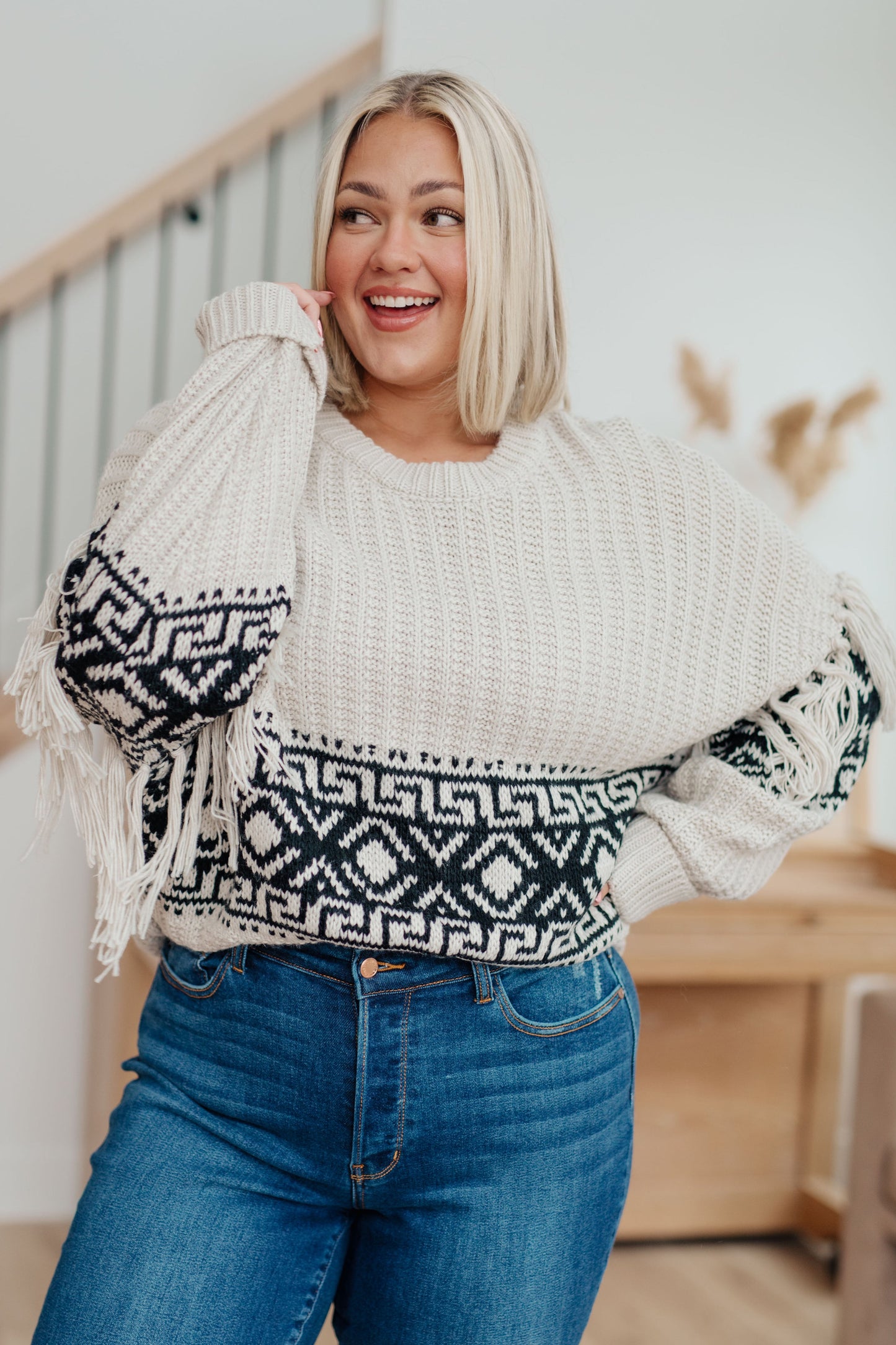 Woman's mid-weight sweater with a geometric print, featuring fringe trim, a ribbed crew neckline, long balloon sleeves with drop shoulders, and a comfort fit.