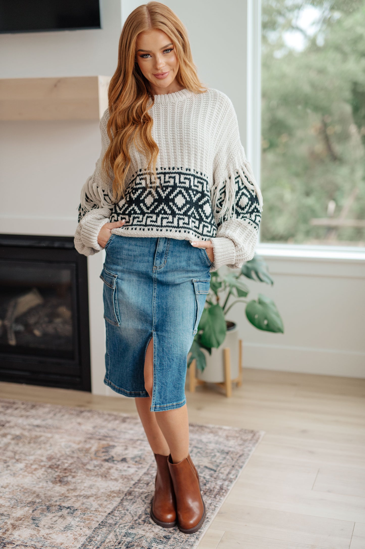 Woman's mid-weight sweater with a geometric print, featuring fringe trim, a ribbed crew neckline, long balloon sleeves with drop shoulders, and a comfort fit.