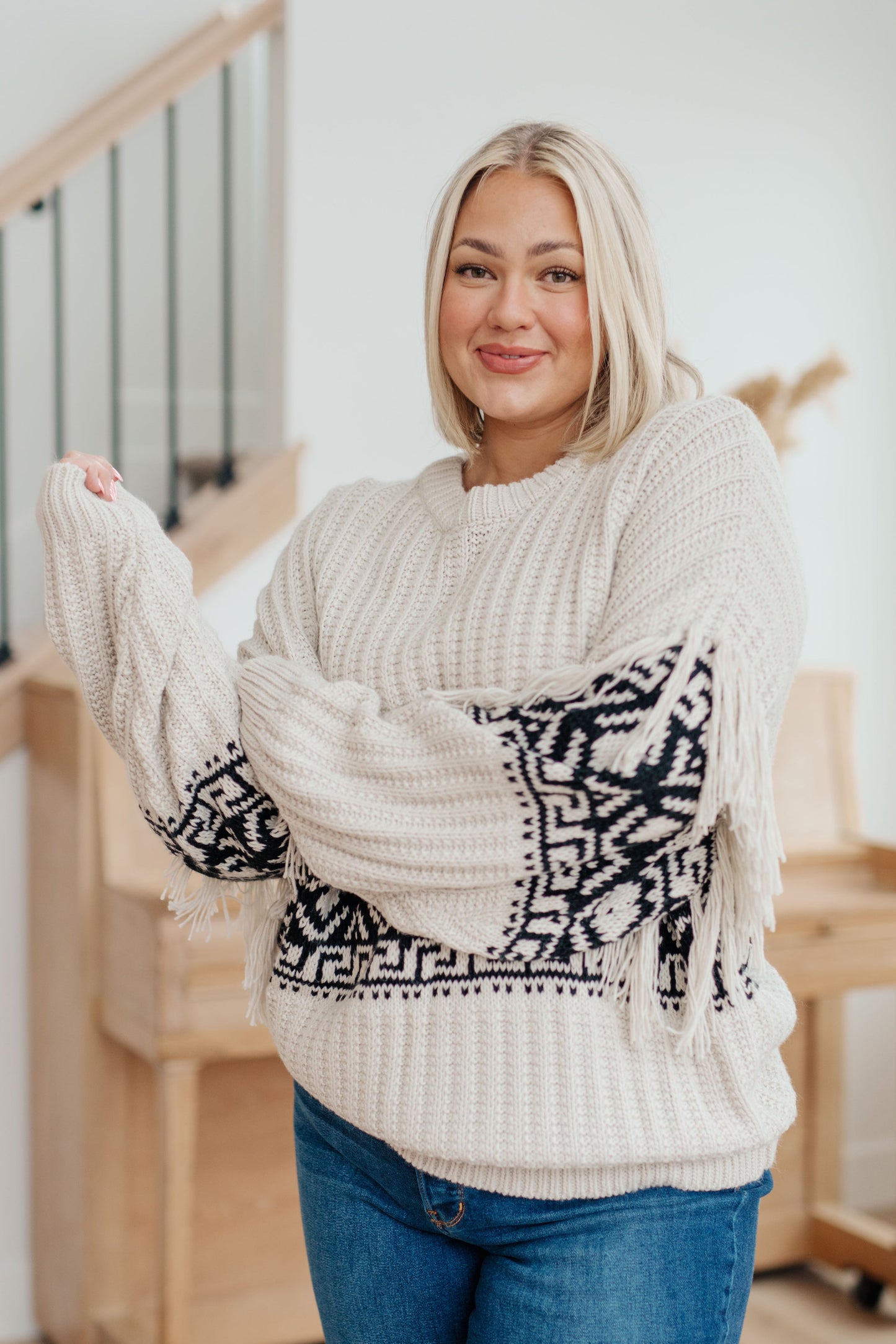 Woman's mid-weight sweater with a geometric print, featuring fringe trim, a ribbed crew neckline, long balloon sleeves with drop shoulders, and a comfort fit.