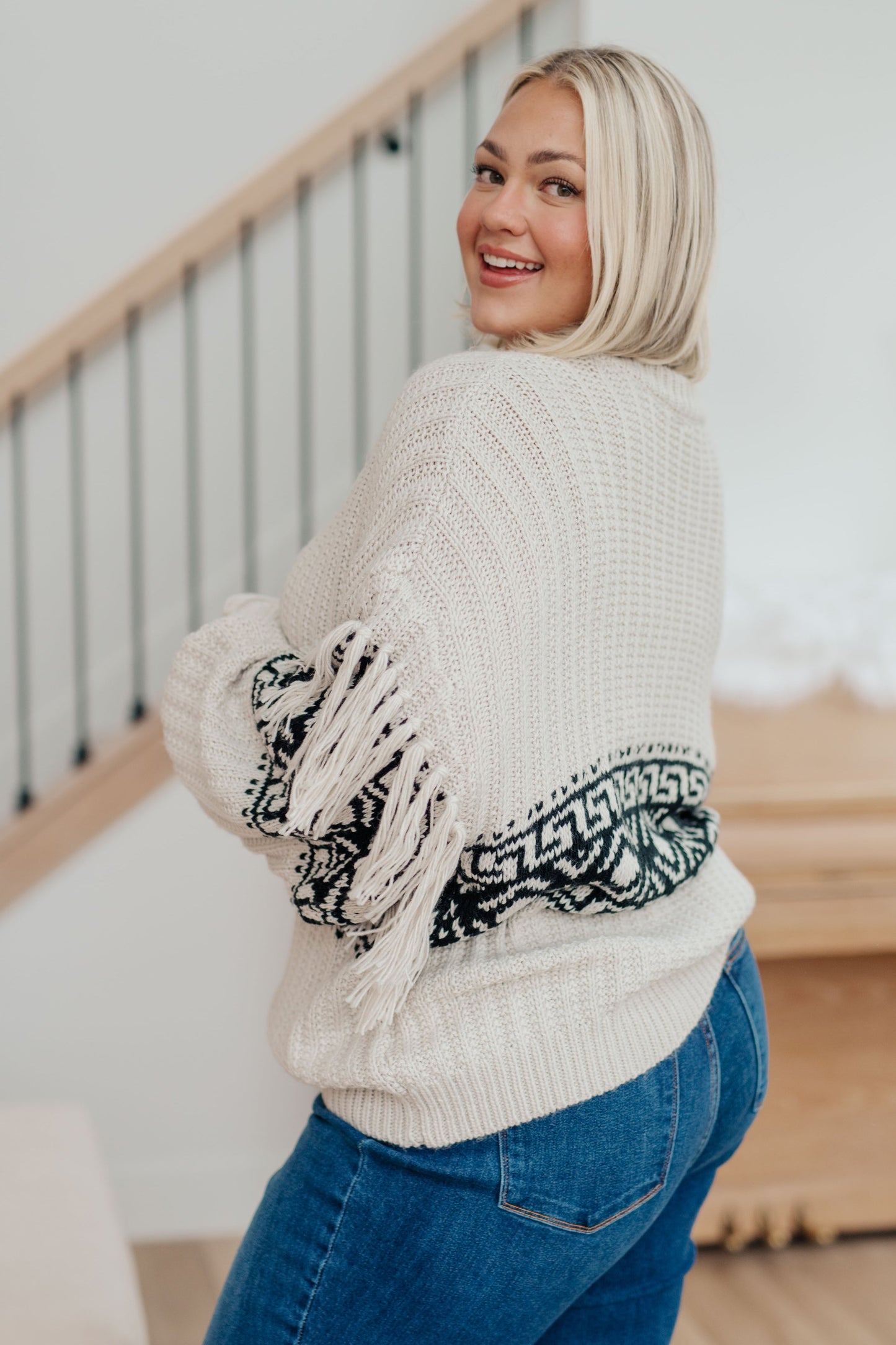 Woman's mid-weight sweater with a geometric print, featuring fringe trim, a ribbed crew neckline, long balloon sleeves with drop shoulders, and a comfort fit.