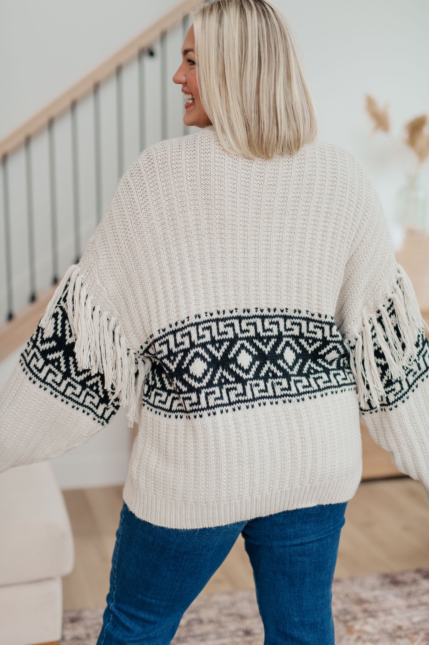 Woman's mid-weight sweater with a geometric print, featuring fringe trim, a ribbed crew neckline, long balloon sleeves with drop shoulders, and a comfort fit.