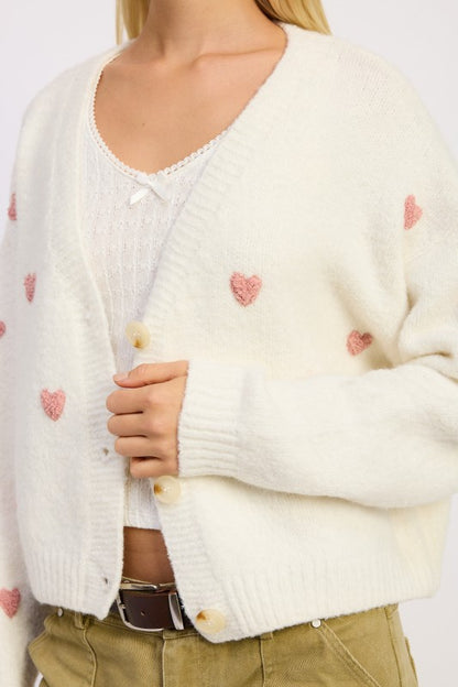 Close-up of Donna Cropped Cardigan showing embroidered heart details.
