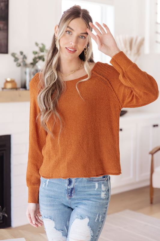 Front view of Dorothy Pullover Sweater in rust with raglan sleeves and exposed seams