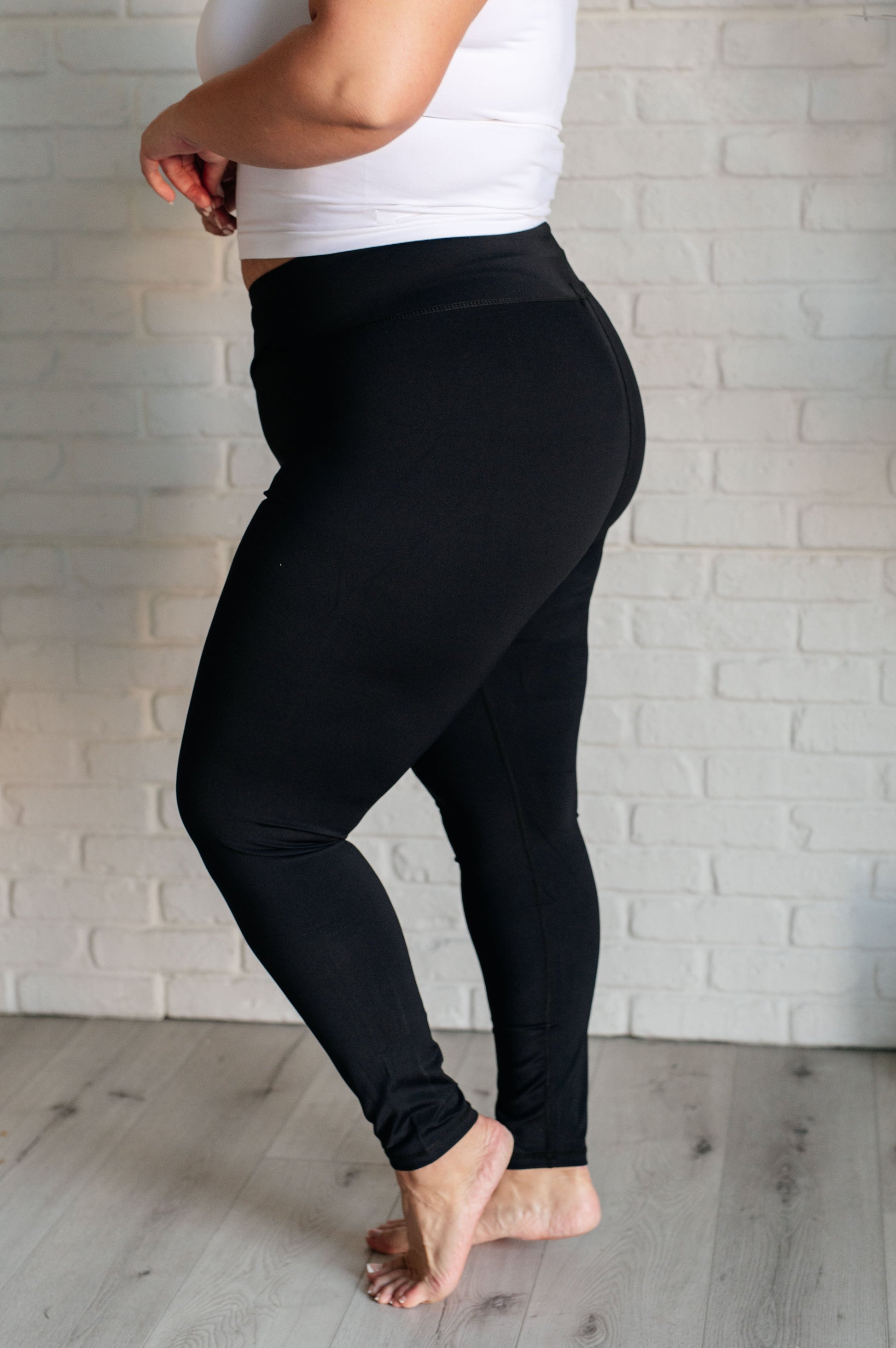 Women's black athletic leggings with a V-waistline, designed for comfort and performance.