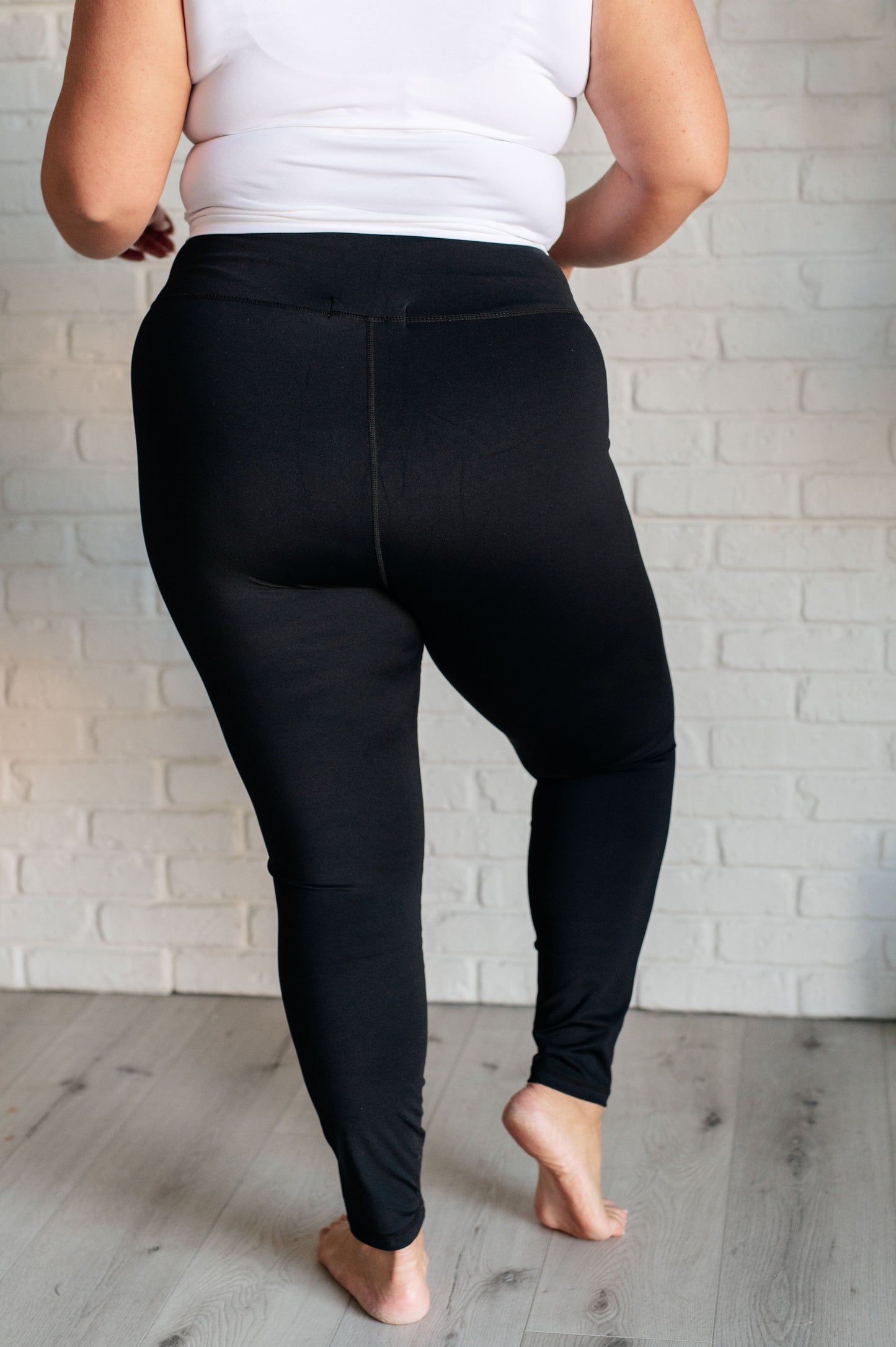 Women's black athletic leggings with a V-waistline, designed for comfort and performance.