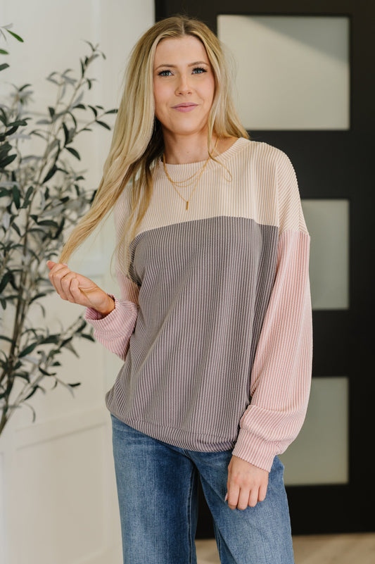 Model wearing Jaylani Color Block Pullover in gray, pink, and cream knit