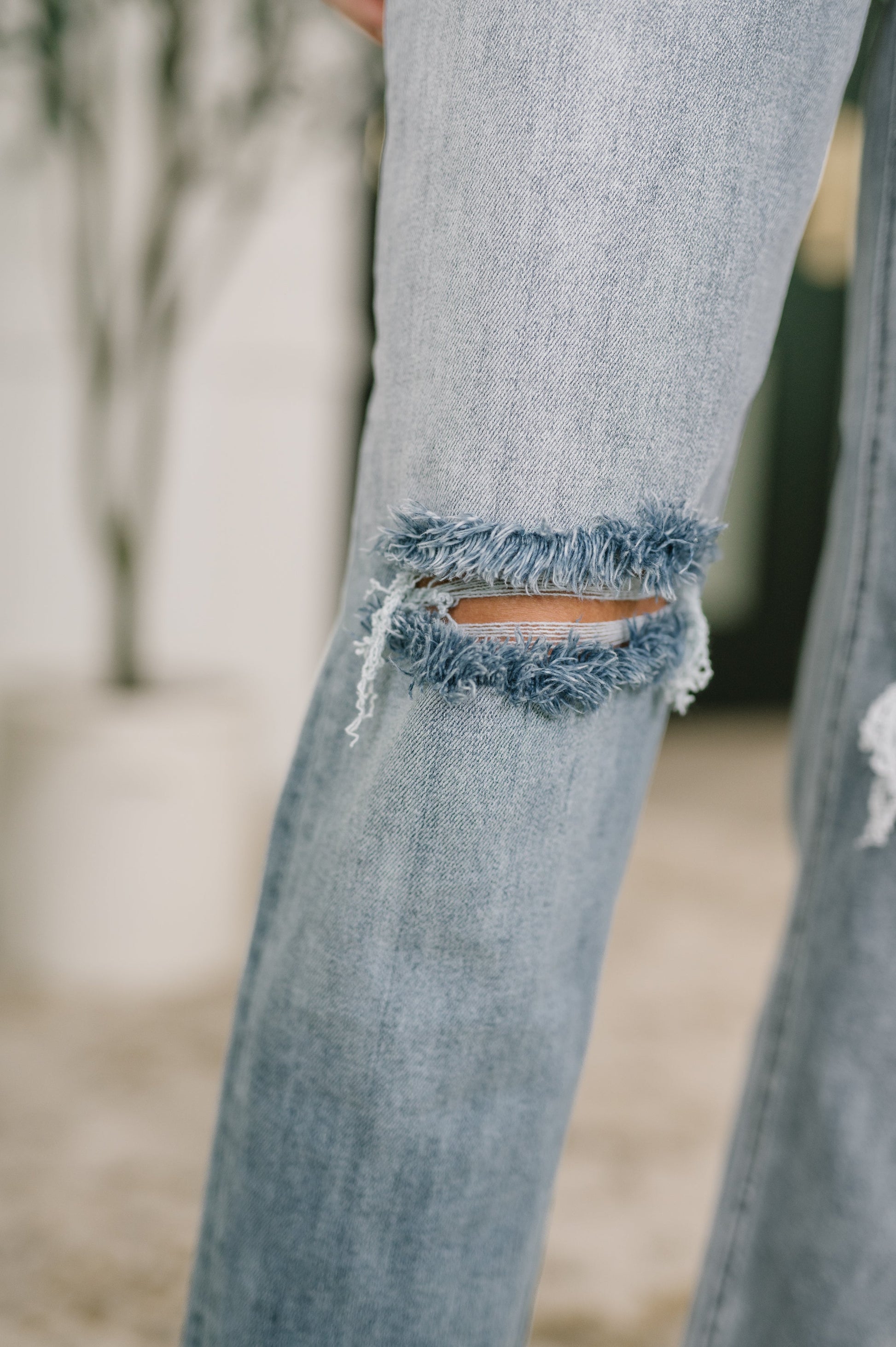 Close up of Elaine Mid Rise Boyfriend Jeans by Judy Blue distressed knee detail.