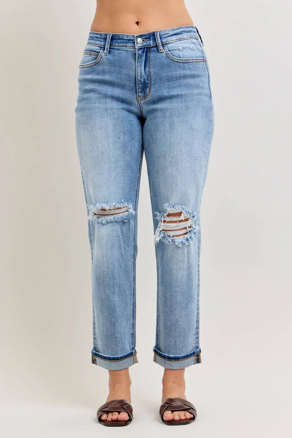 Model wearing Elaine Mid Rise Boyfriend Jeans by Judy Blue in medium wash denim with distressed details.