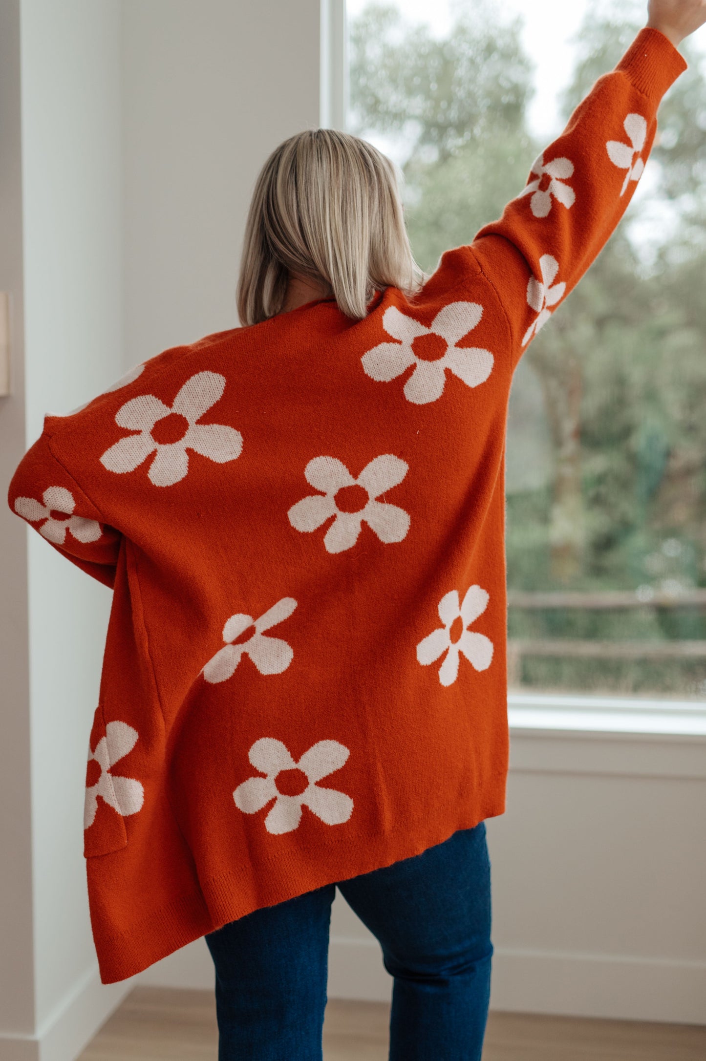 Back view of plus size Edna Floral Cardigan with bold florals and longline open silhouette.