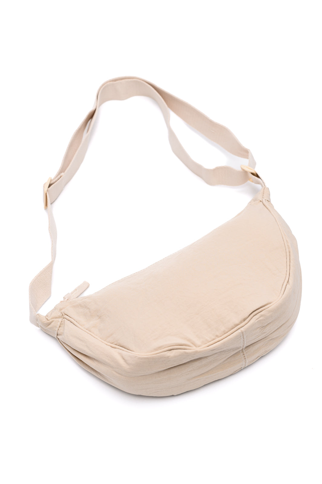 Essie Round Mini Crossbody Bag in off white, durable nylon dumpling bag with zipper closure, two 5x5 inch patch pockets, and adjustable plastic strap for versatile comfort.