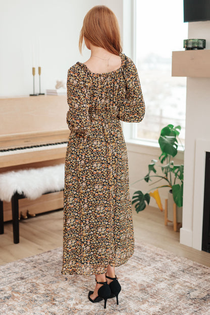 Ditsy floral black/orange maxi dress with square neckline and ruffle trim, back angle.