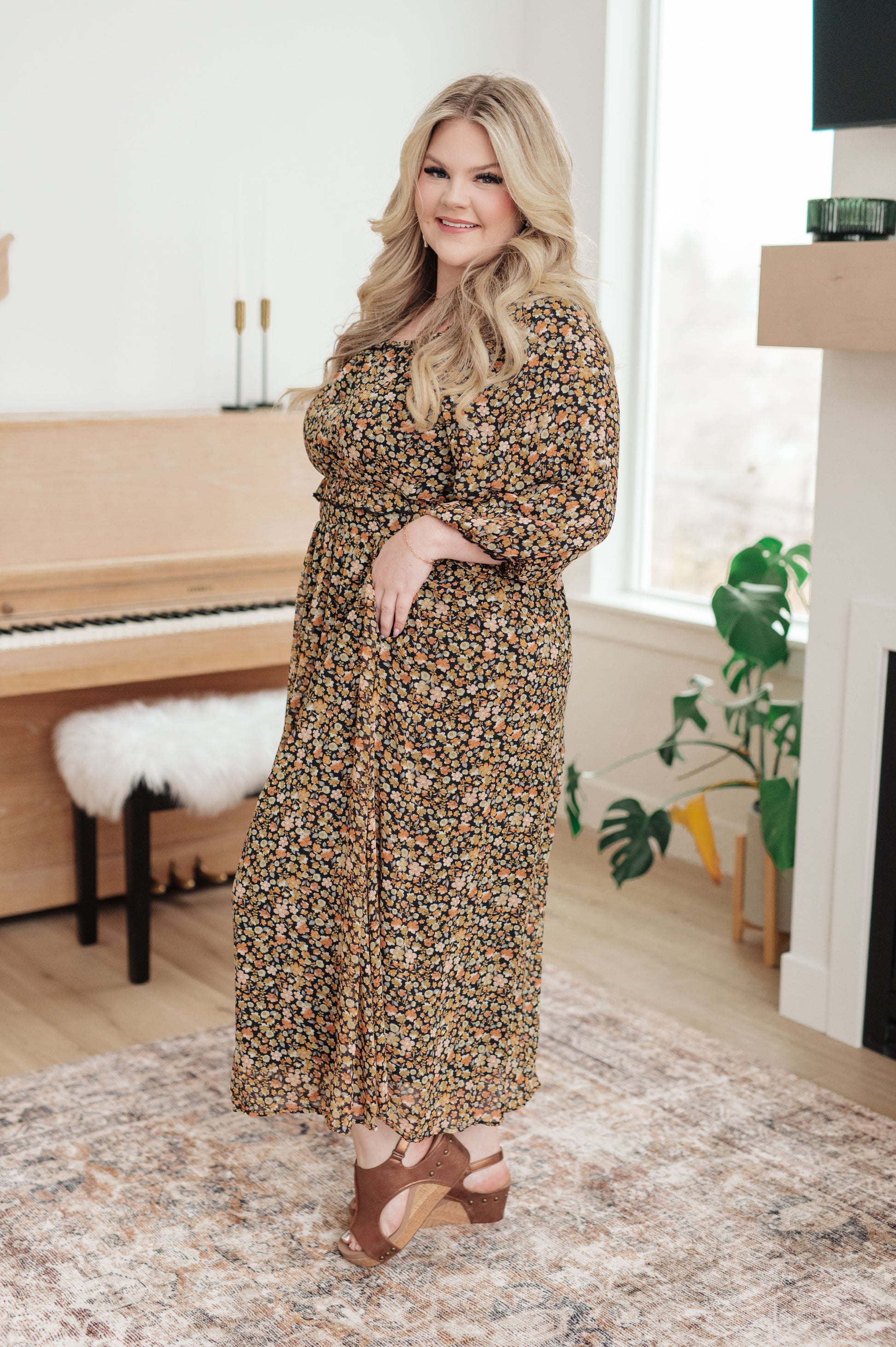 Curvy floral chiffon maxi dress with 3/4 sheer sleeves and ruffle trim, side view.