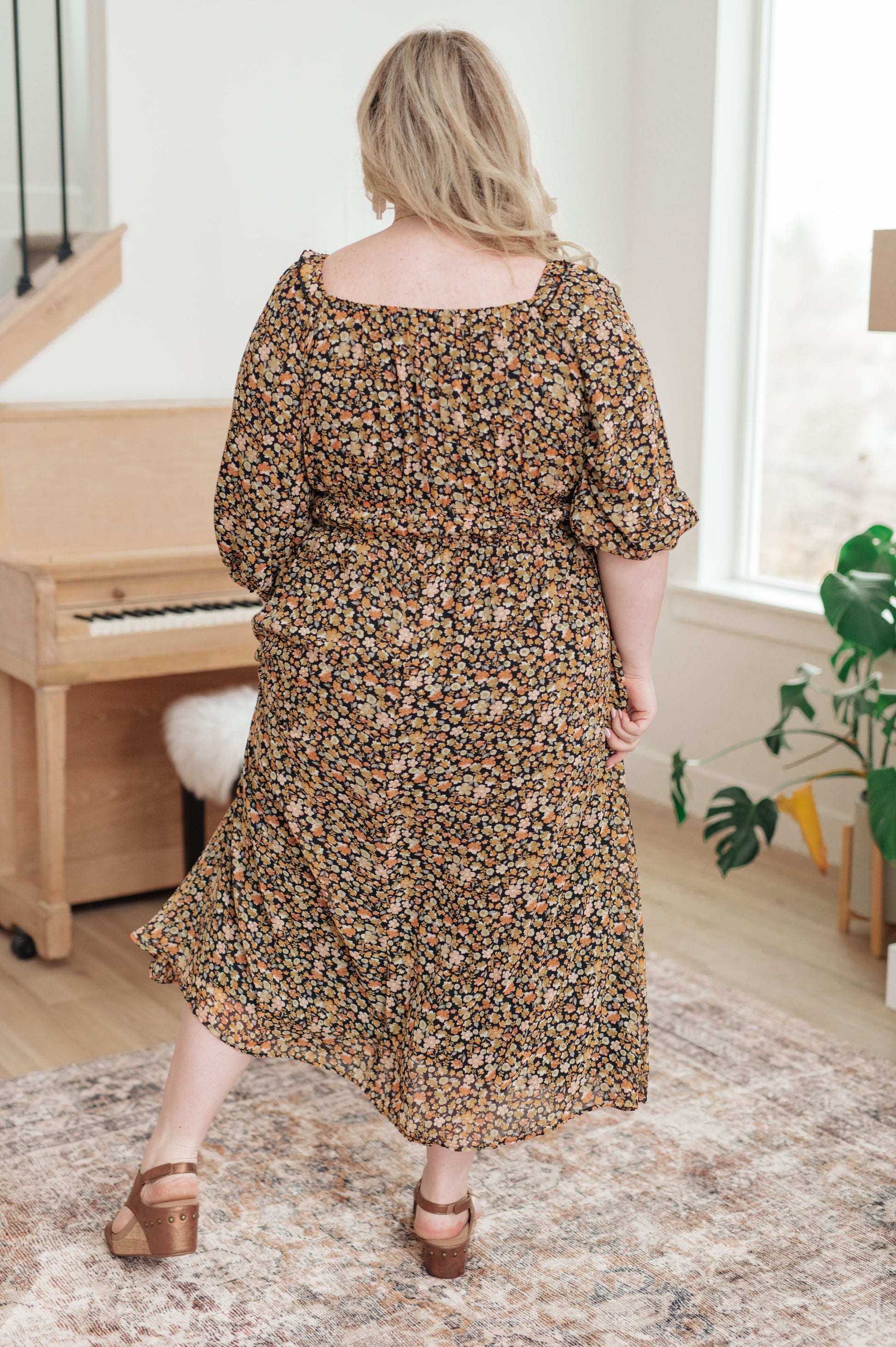 Plus size floral maxi dress with elastic waistband and 3/4 sheer sleeves, back view.