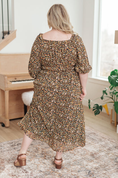 Plus size floral maxi dress with elastic waistband and 3/4 sheer sleeves, back view.
