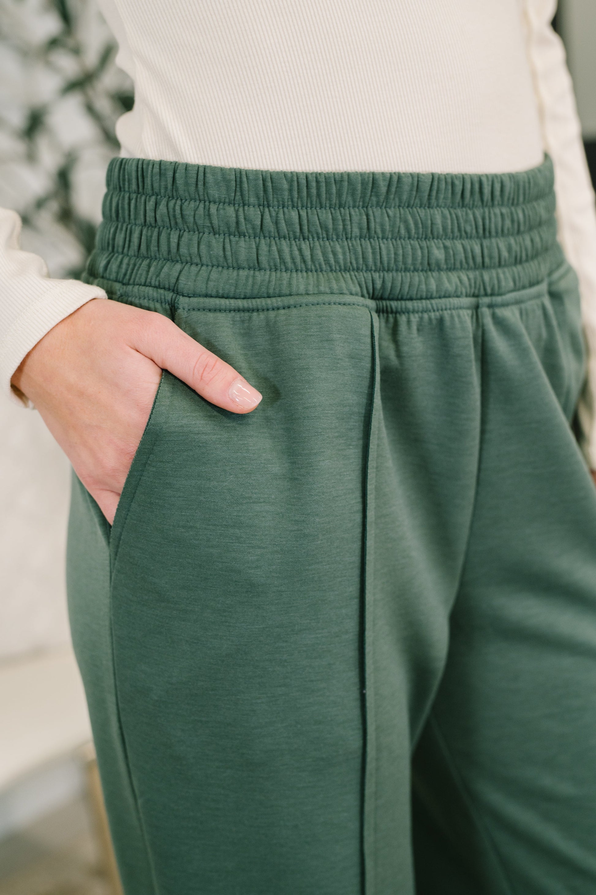 Close-up of Evani Jogger Bottoms showing cased elastic waistband and scuba fabric.