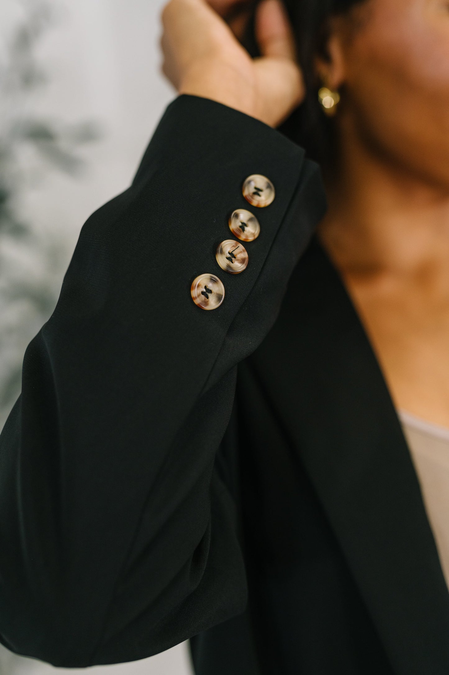Detail shot of Everli Blazer in Black showing sleeve button closure.