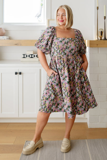 Plus size full body view of model wearing Skyla Floral Dress in pink floral with square neckline.