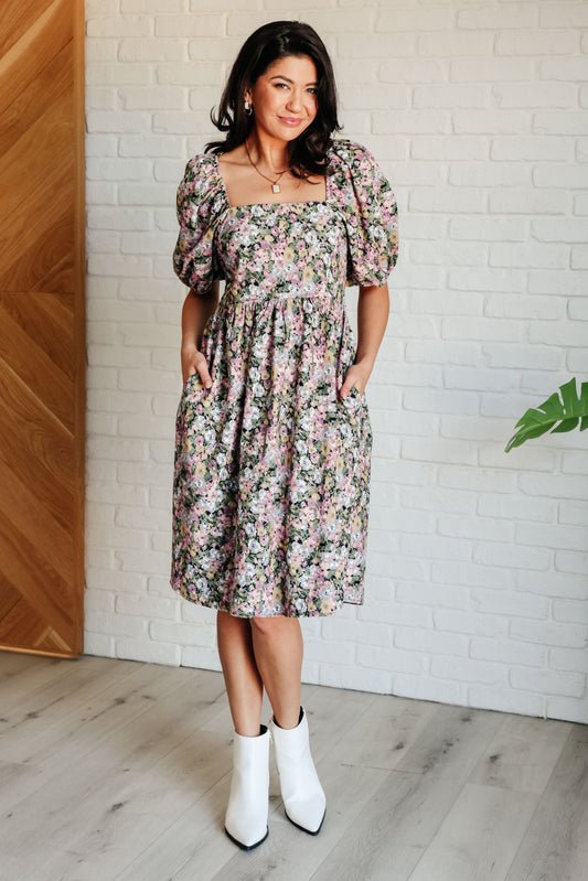 Front full body view of model wearing Skyla Floral Dress with puff sleeves and square neckline.
