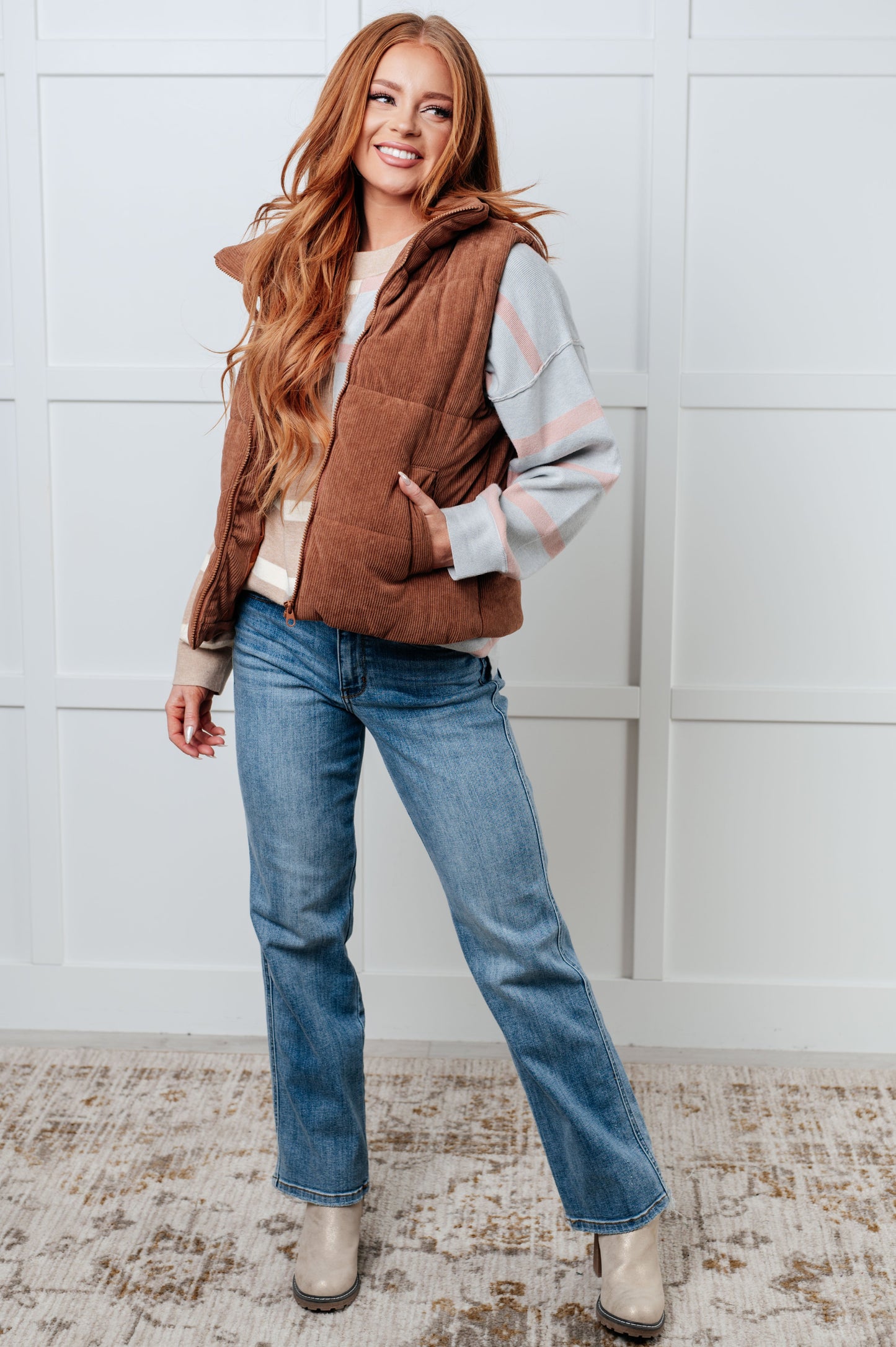 A women's sweater in beige and light gray stripes, made of midweight sweater knit fabric. It features a banded micro-ribbed neckline, long drop-shoulder sleeves with banded micro-ribbed cuffs, exposed seam details, and side slits.