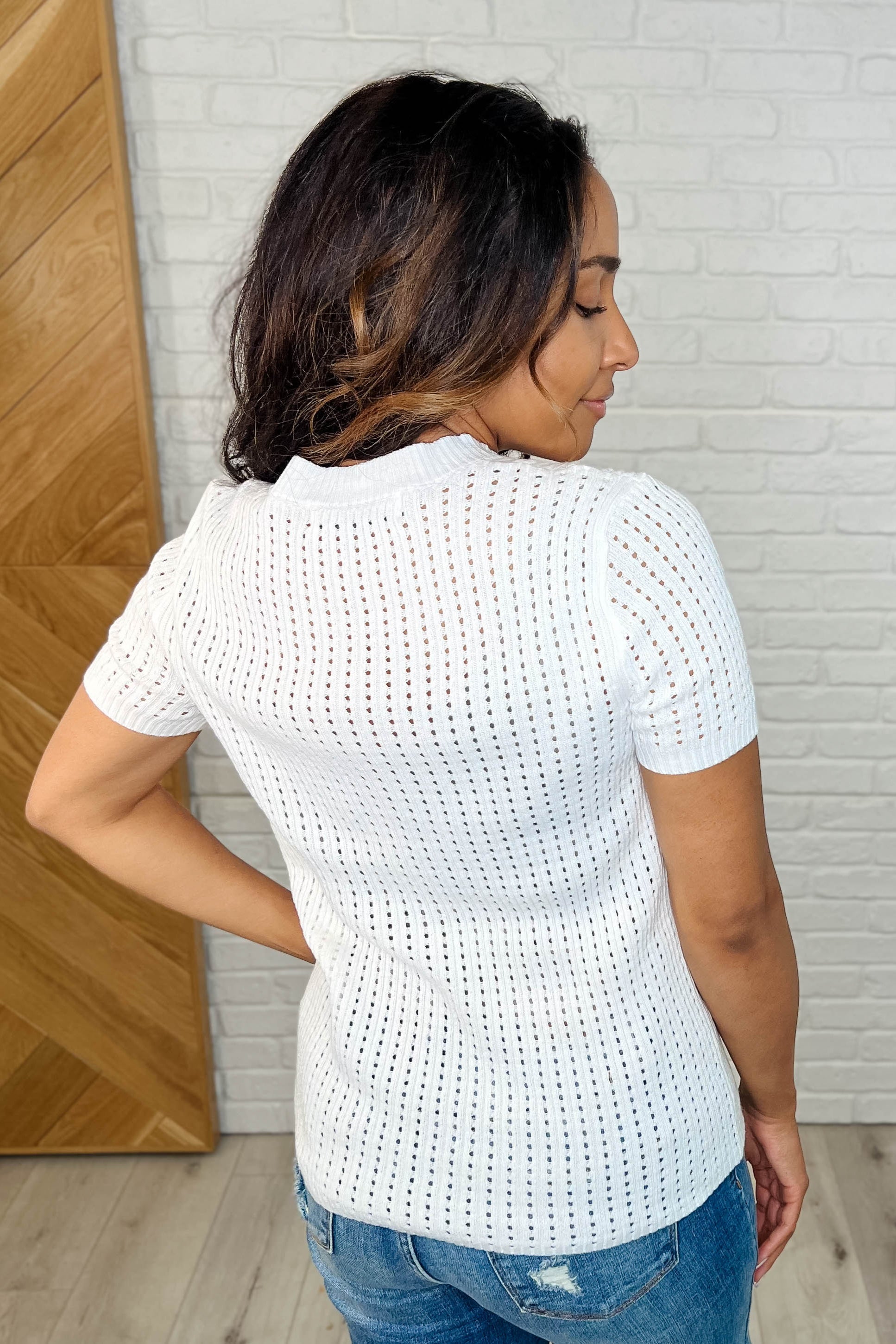 Back side of Felicia tee with round neckline, short sleeves, and soft textured knit fabric.