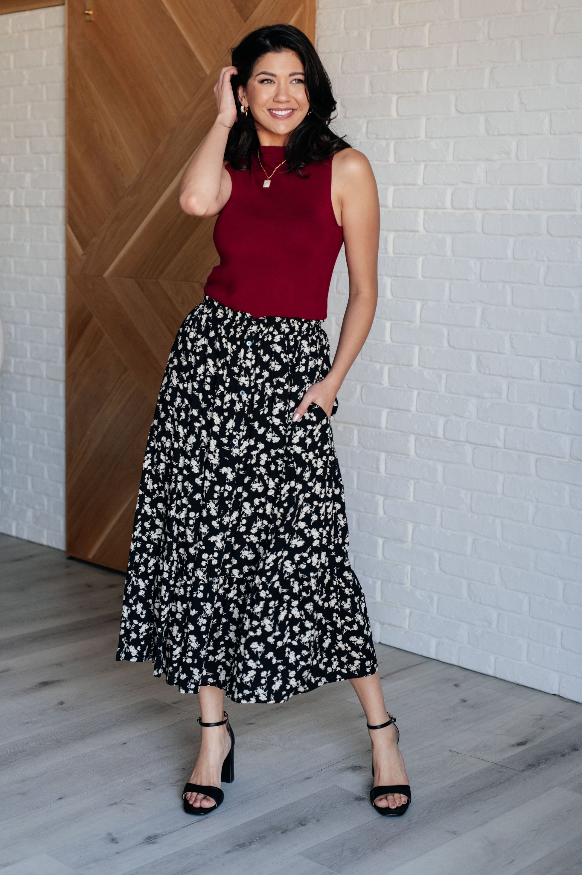 Model wearing Virginia Floral Skirt styled with heels, showing flowy silhouette.