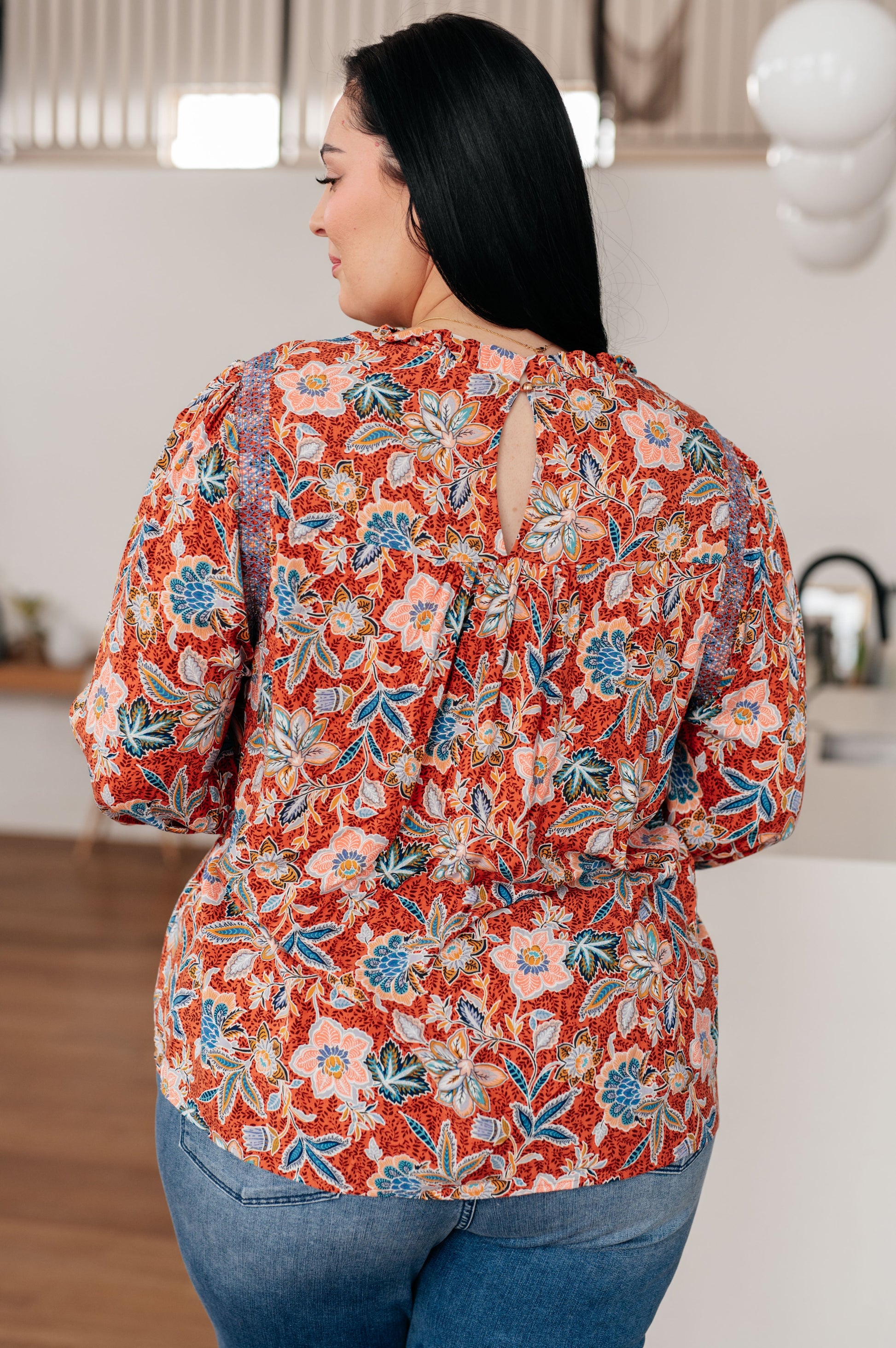 Plus size back view of Blair Floral Blouse highlighting lightweight woven rust floral fabric and relaxed fit.