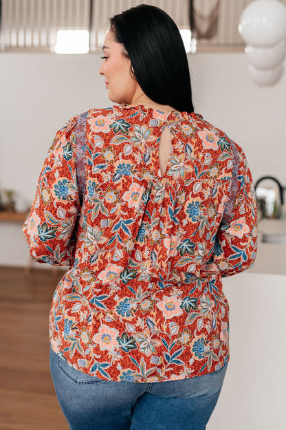 Plus size back view of Blair Floral Blouse highlighting lightweight woven rust floral fabric and relaxed fit.