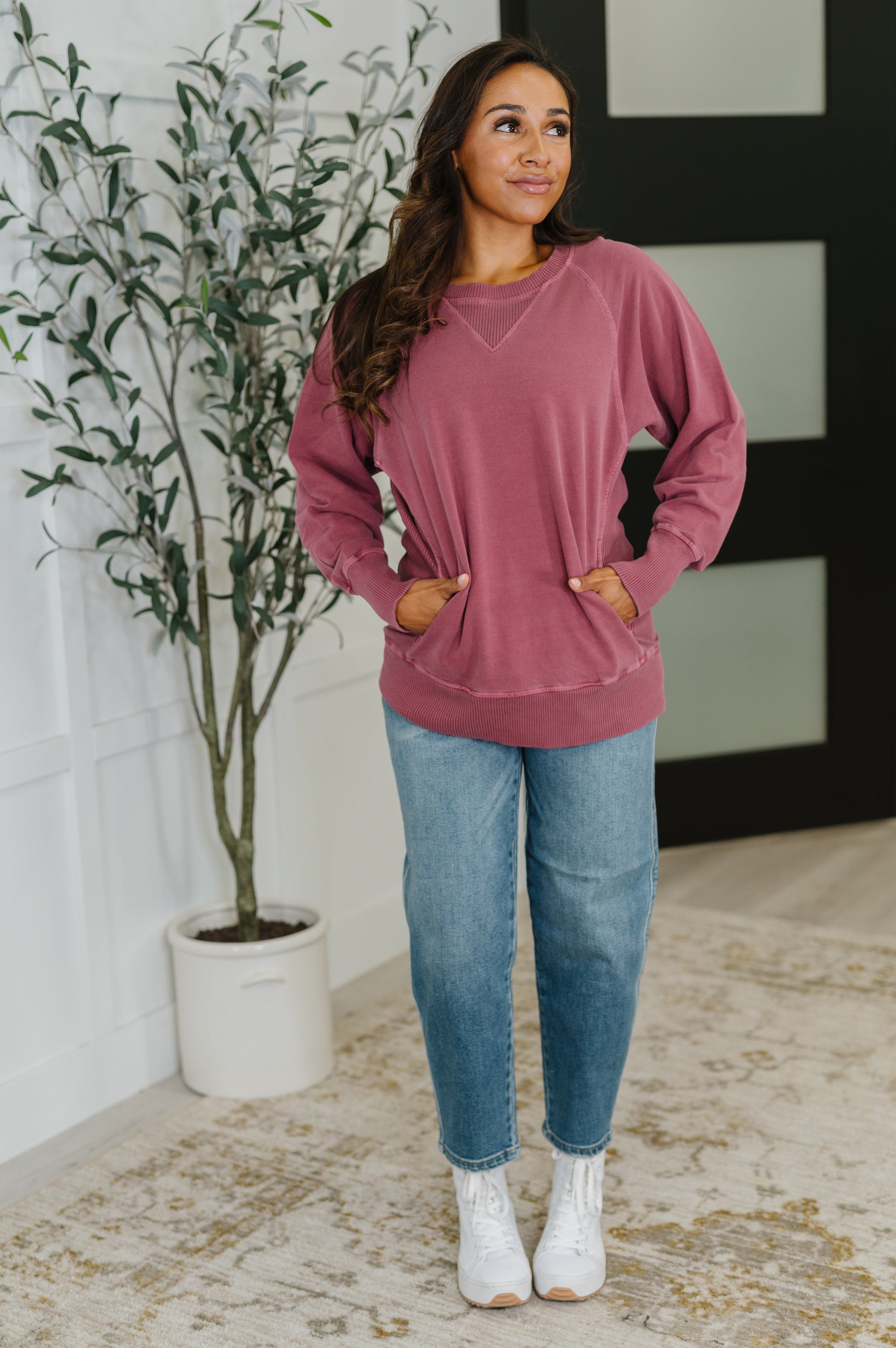 Full body look with Hallie Relaxed Pullover in cabernet styled with jeans, ribbed hemline and functional pockets visible