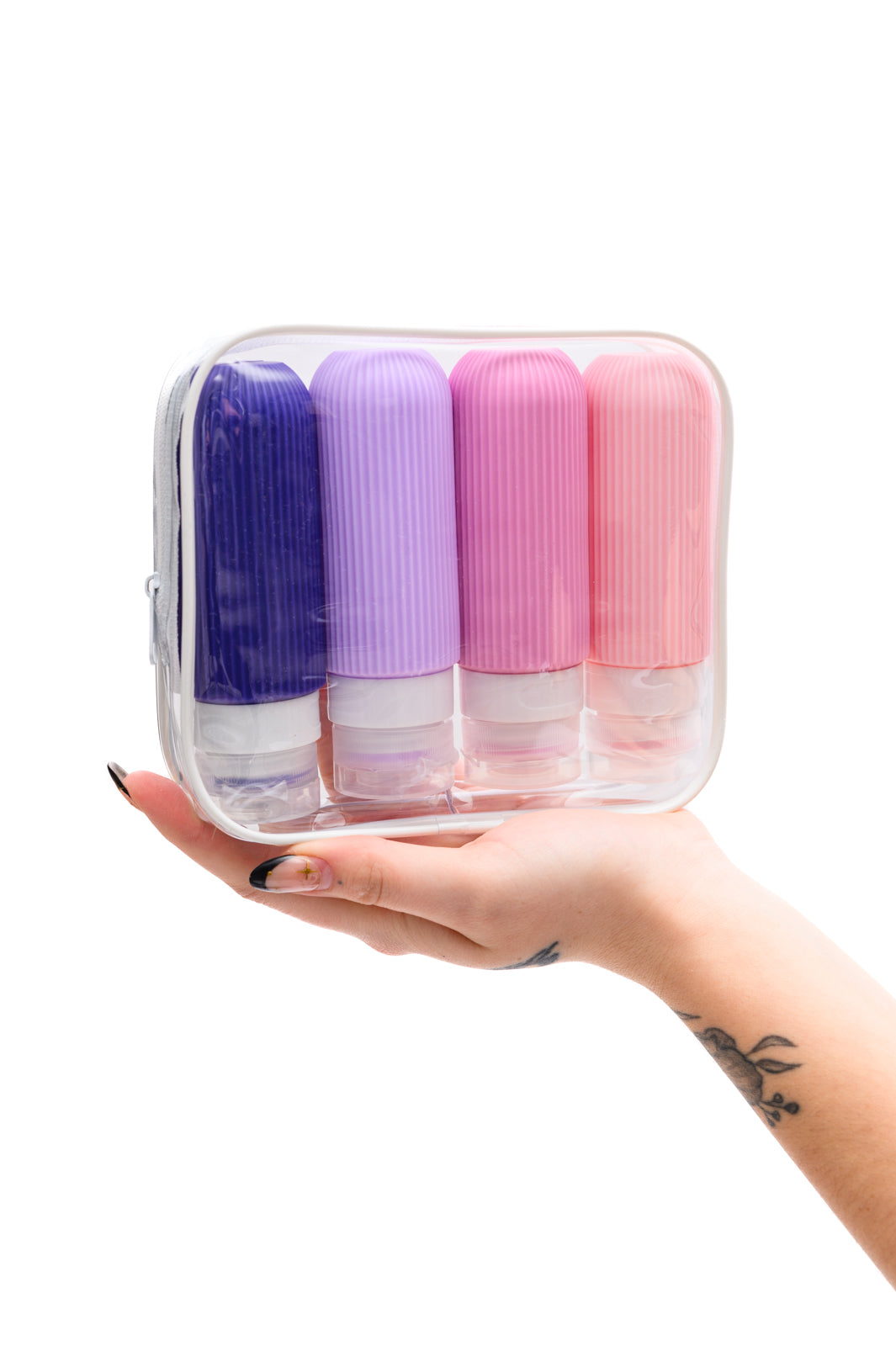 Lavender and pink silicone toiletry travel bottles, leak-proof, TSA-approved, with wide mouths and no-drip valves for easy use.