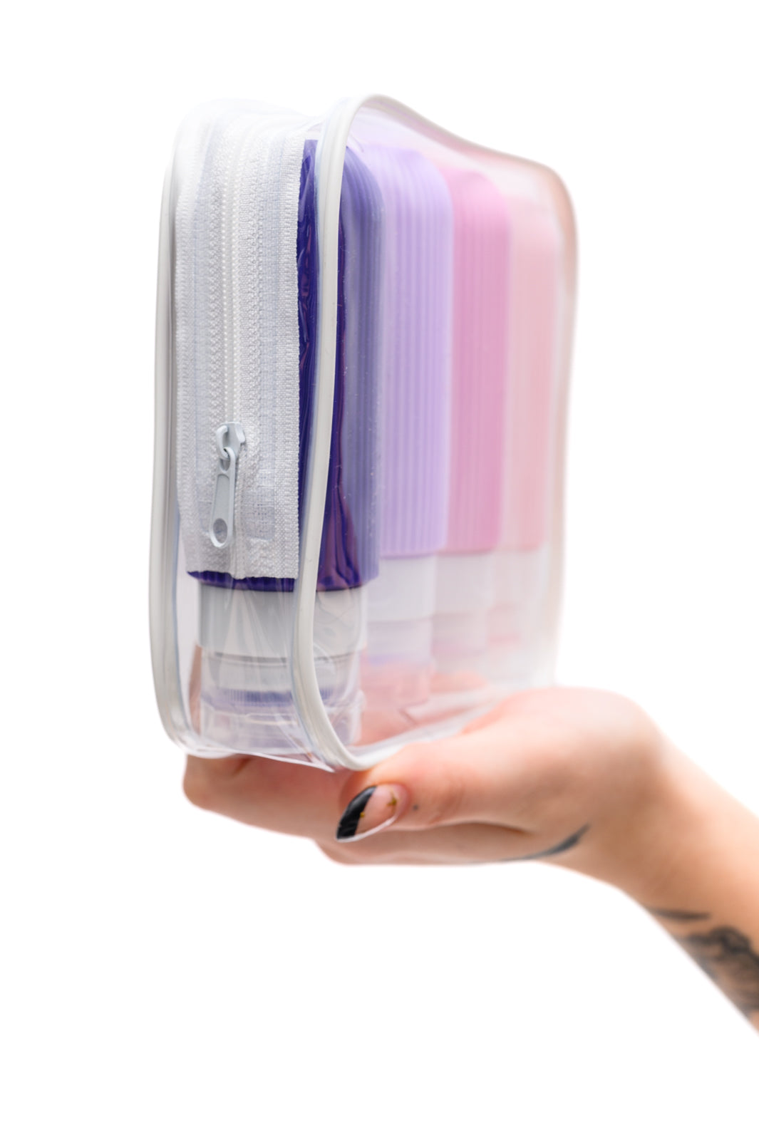 Side view of lavender and pink silicone toiletry travel bottles, leak-proof, TSA-approved, with wide mouths and no-drip valves for easy use.