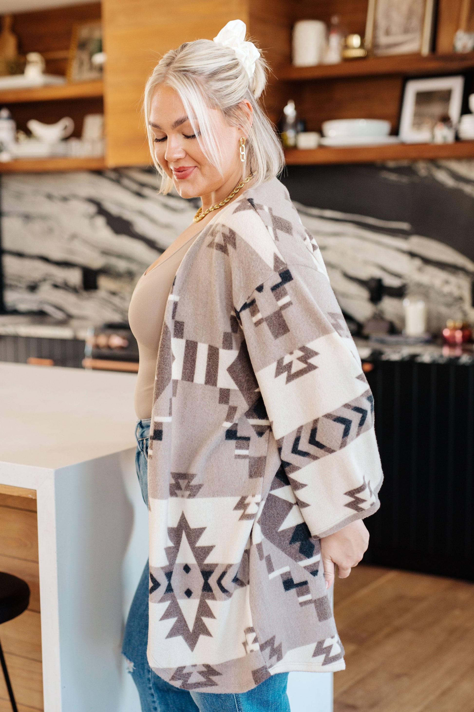 Women's blanket kimono cardigan in gray, brown, white and black with a geometric print. Made from brushed hacci fabric, featuring 3/4 sleeves, a drop shoulder, and an open front neckline.