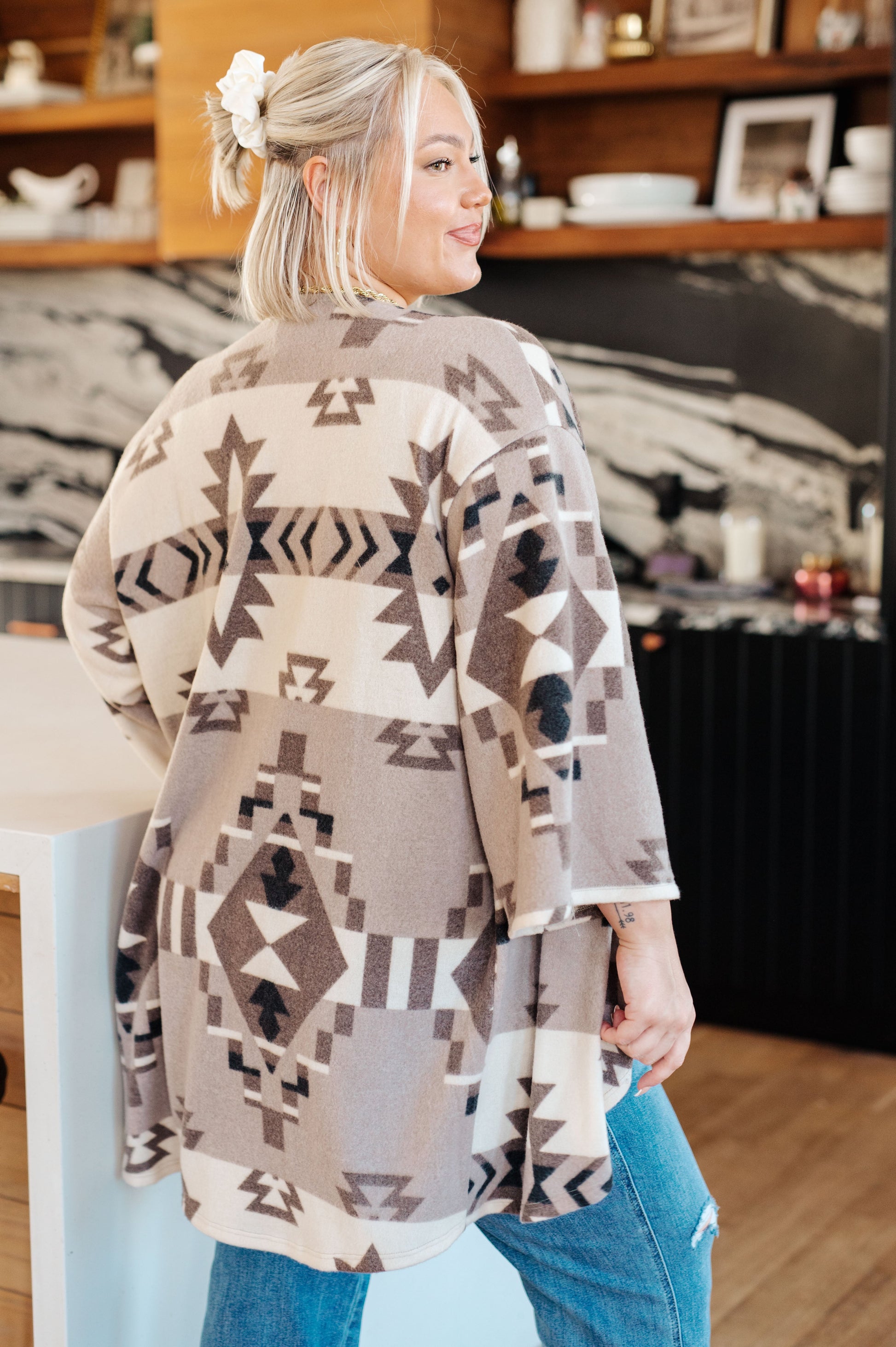 Women's blanket kimono cardigan in gray, brown, white and black with a geometric print. Made from brushed hacci fabric, featuring 3/4 sleeves, a drop shoulder, and an open front neckline.