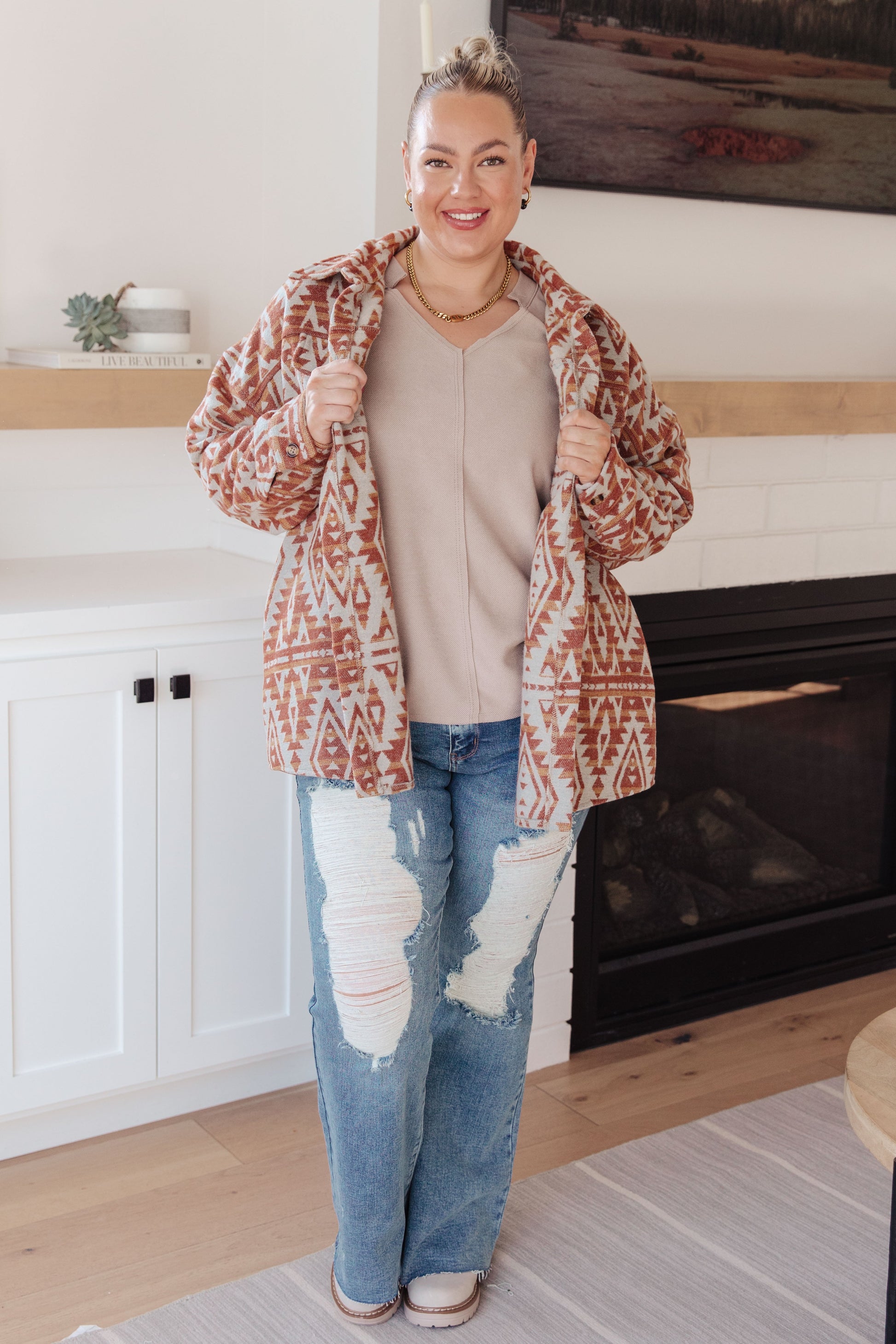  Women's mid-weight brushed flannel jacket featuring an Aztec print, collared neckline, long sleeves, button front closure, buttoned flap pockets, and side pockets.