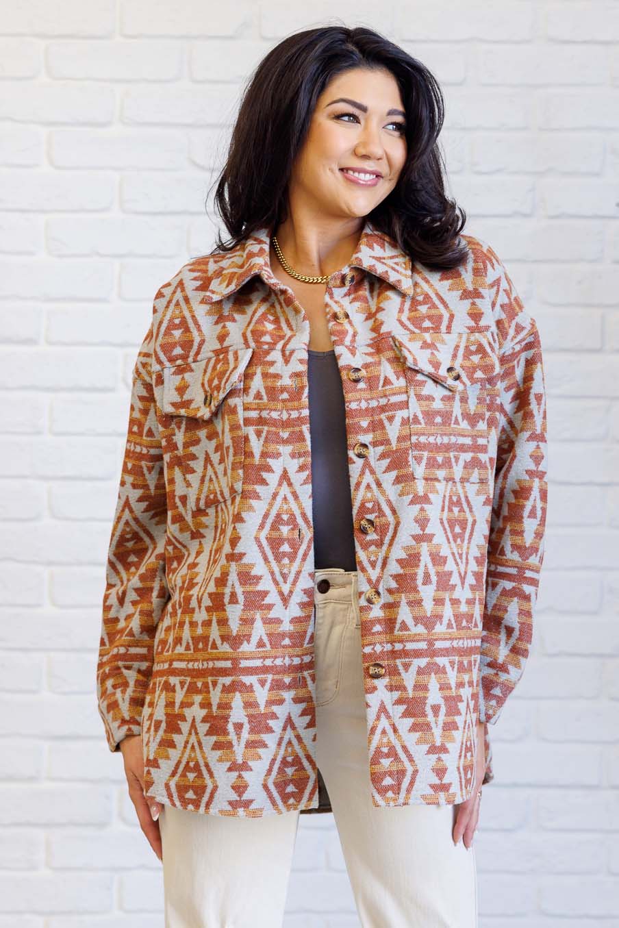  Women's mid-weight brushed flannel jacket featuring an Aztec print, collared neckline, long sleeves, button front closure, buttoned flap pockets, and side pockets.