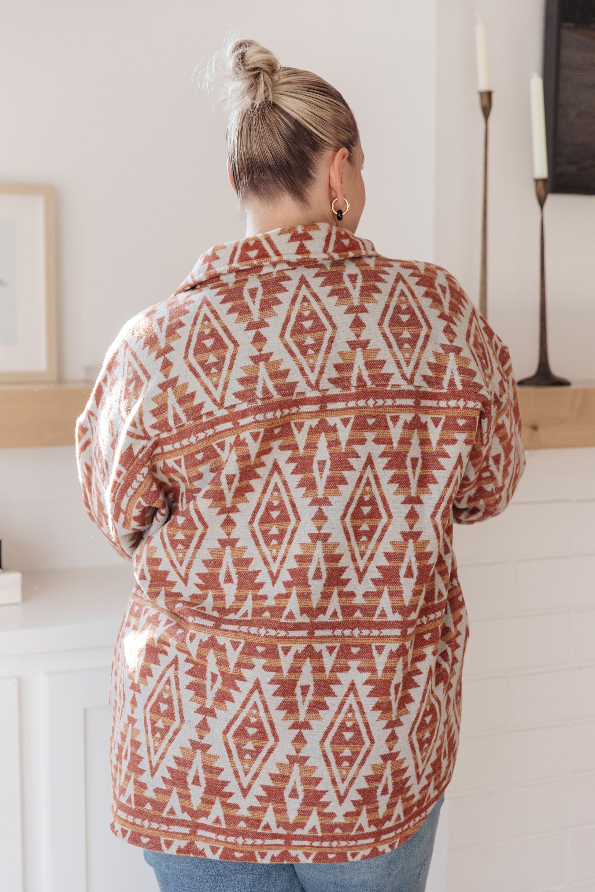  Women's mid-weight brushed flannel jacket featuring an Aztec print, collared neckline, long sleeves, button front closure, buttoned flap pockets, and side pockets.