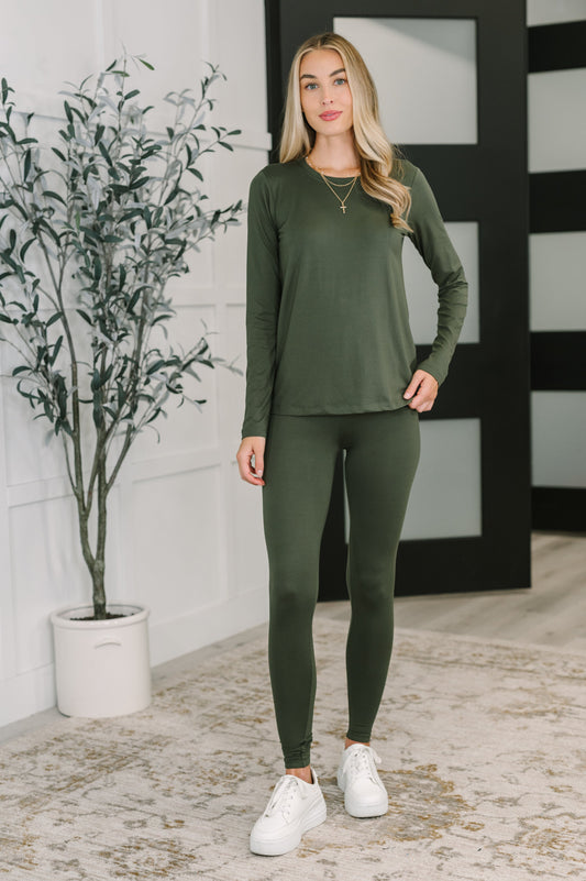 Model wearing Gatlin Cozy Set in Dark Olive with long sleeves and skinny leg silhouette.