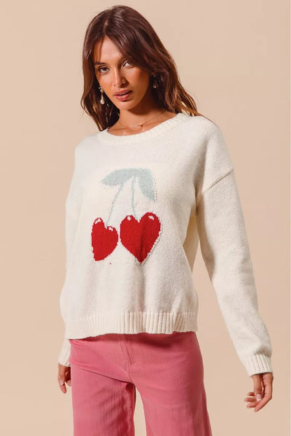 Model adjusting Gina Heart Cherry Sweater showing slightly stretchy fit.