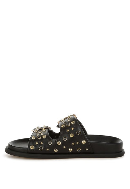 Jayata black faux leather sliders with metallic stud details and soft cushion insoles.
