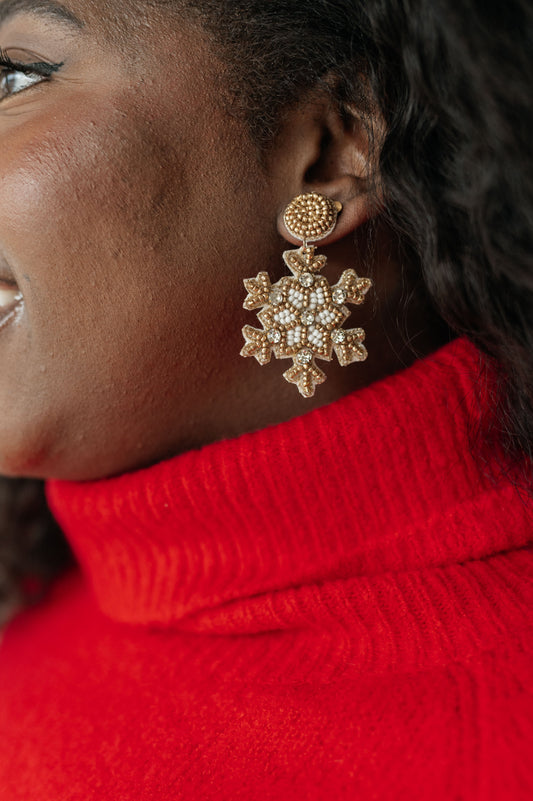 Beaded snowflake post earrings with mounted gemstone accents, 2.5 inches long.