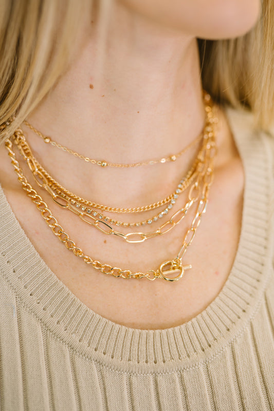 Golden Hour Links Everyday Set featuring five gold chains in varied styles and lengths.