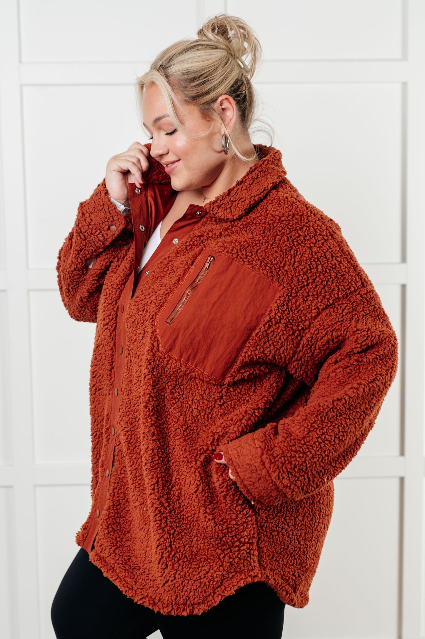 Gresia Sherpa Jacket in cinnamon, featuring soft sherpa material, collared neckline, scooped hemline, snap button closure, zipper pocket, and side pockets, fully lined for comfort.