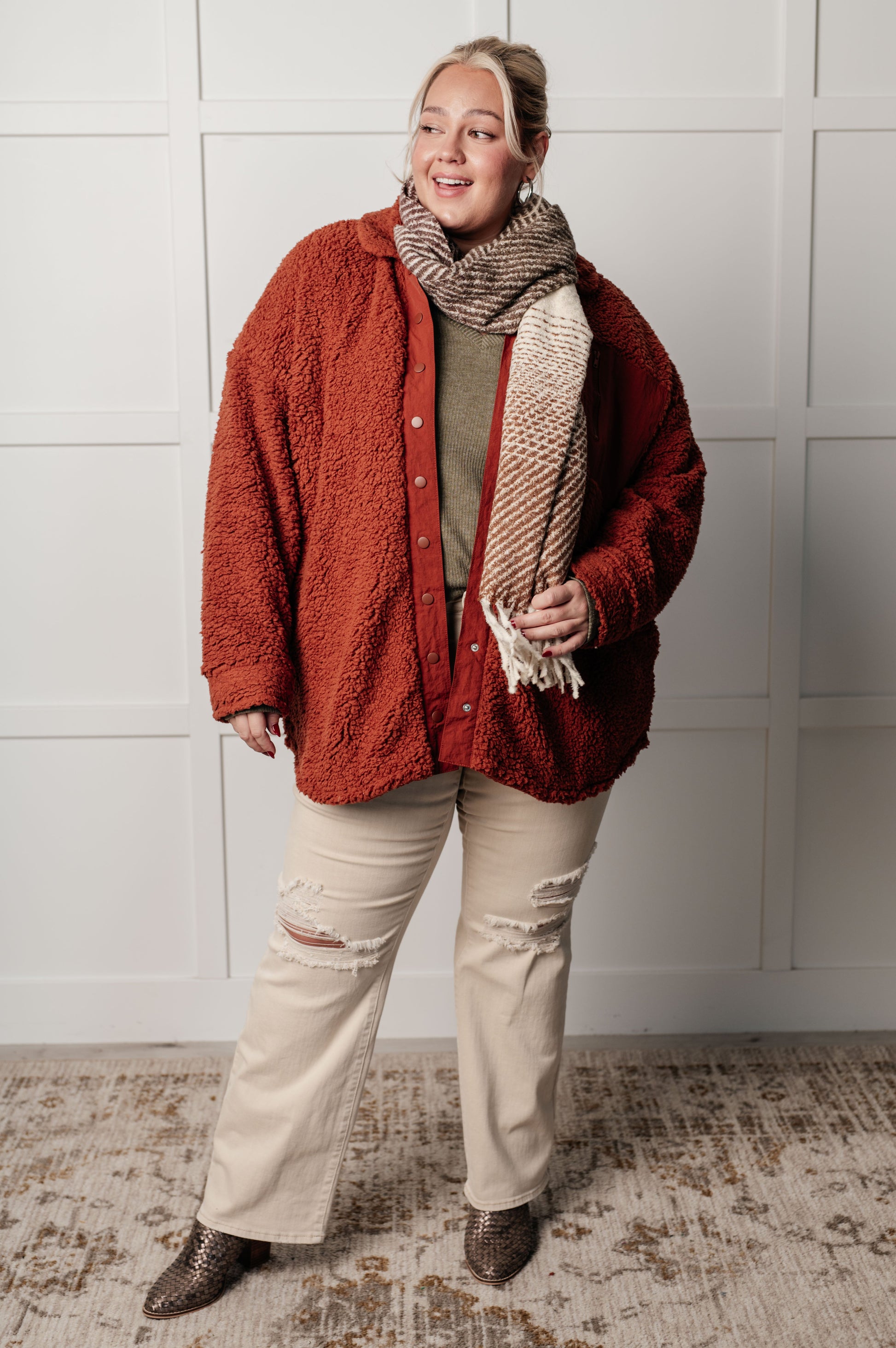 Gresia Sherpa Jacket in cinnamon, featuring soft sherpa material, collared neckline, scooped hemline, snap button closure, zipper pocket, and side pockets, fully lined for comfort.