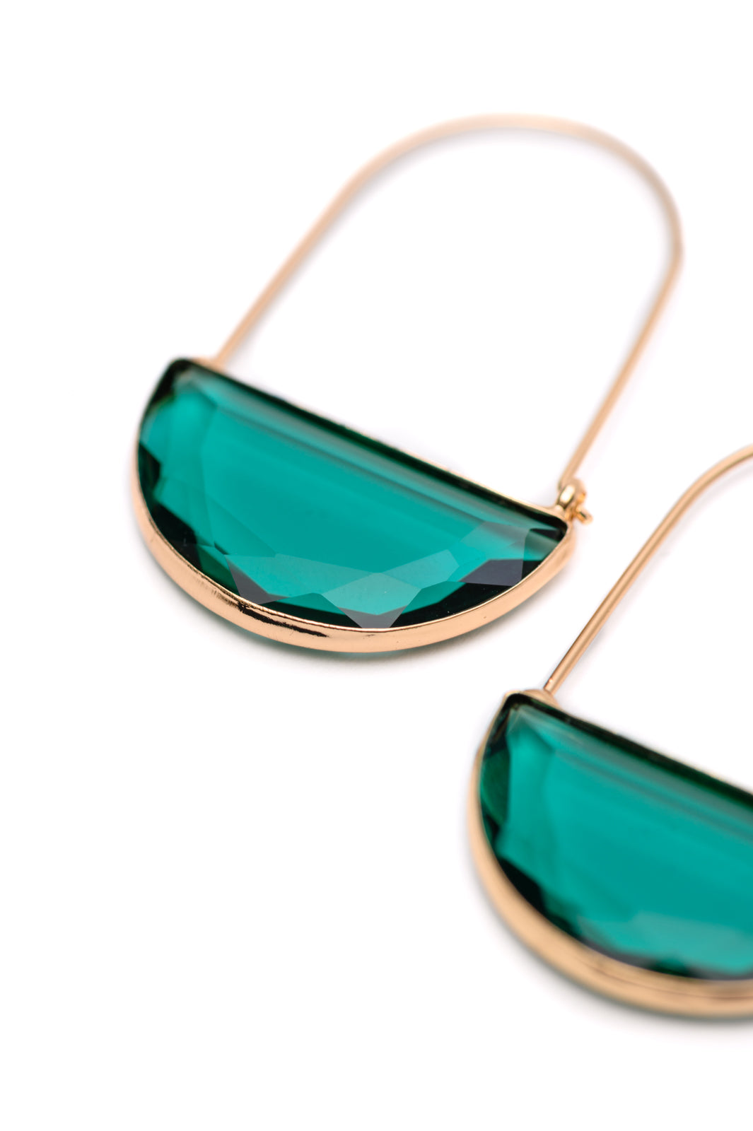 Half Circle Crystal Earrings made of 18K gold-plated metal with teal-colored glass in a half-moon shape, with a safety hook closure. 