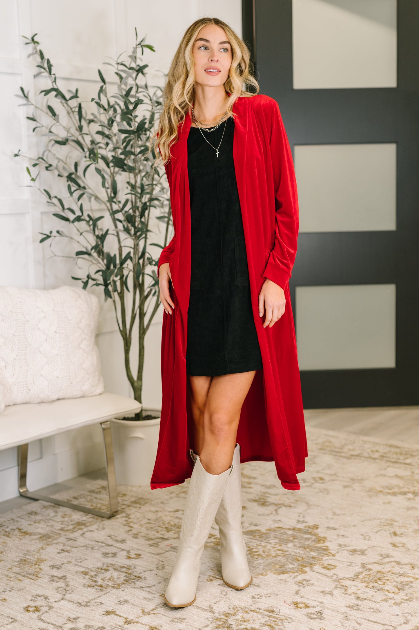 Model wearing Harley Long Velvet Cardigan in red with open front and collared neckline.