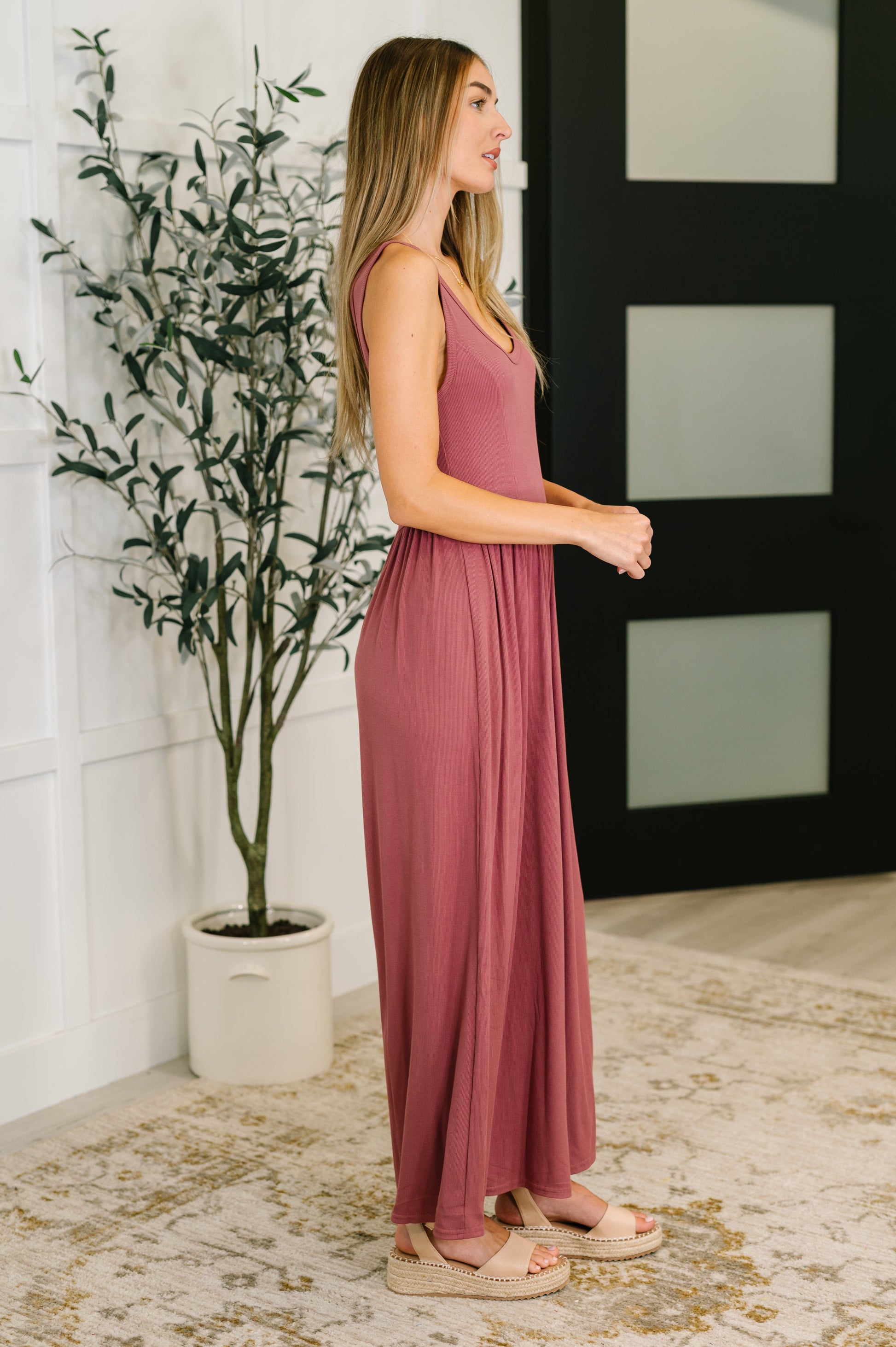 Side view of Pyper Jumpsuit in mauve ribbed knit with elastic waistband and relaxed wide leg