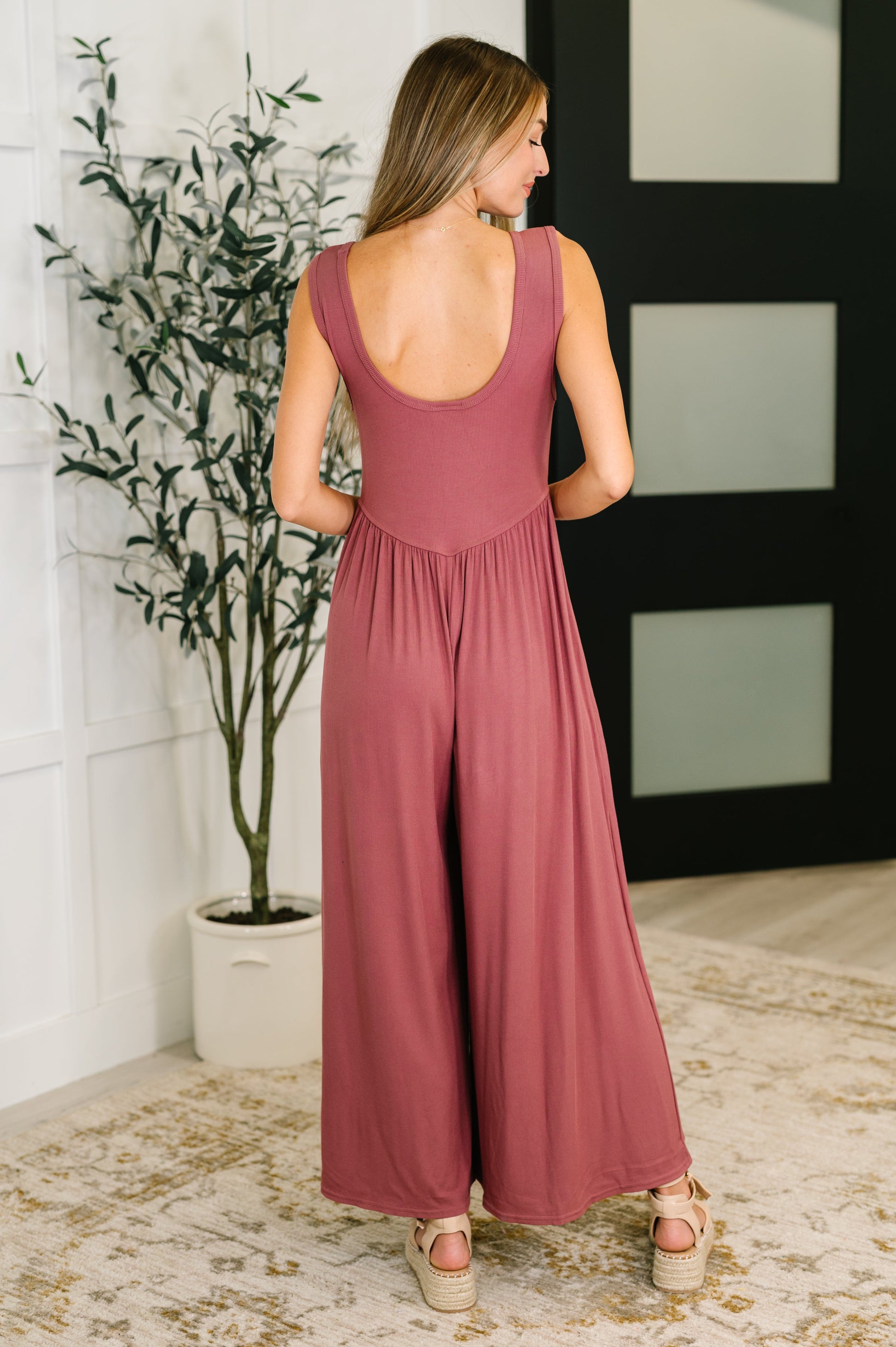 Back view of Pyper Mauve Ribbed Knit Jumpsuit with wide-leg silhouette and soft stretch fabric