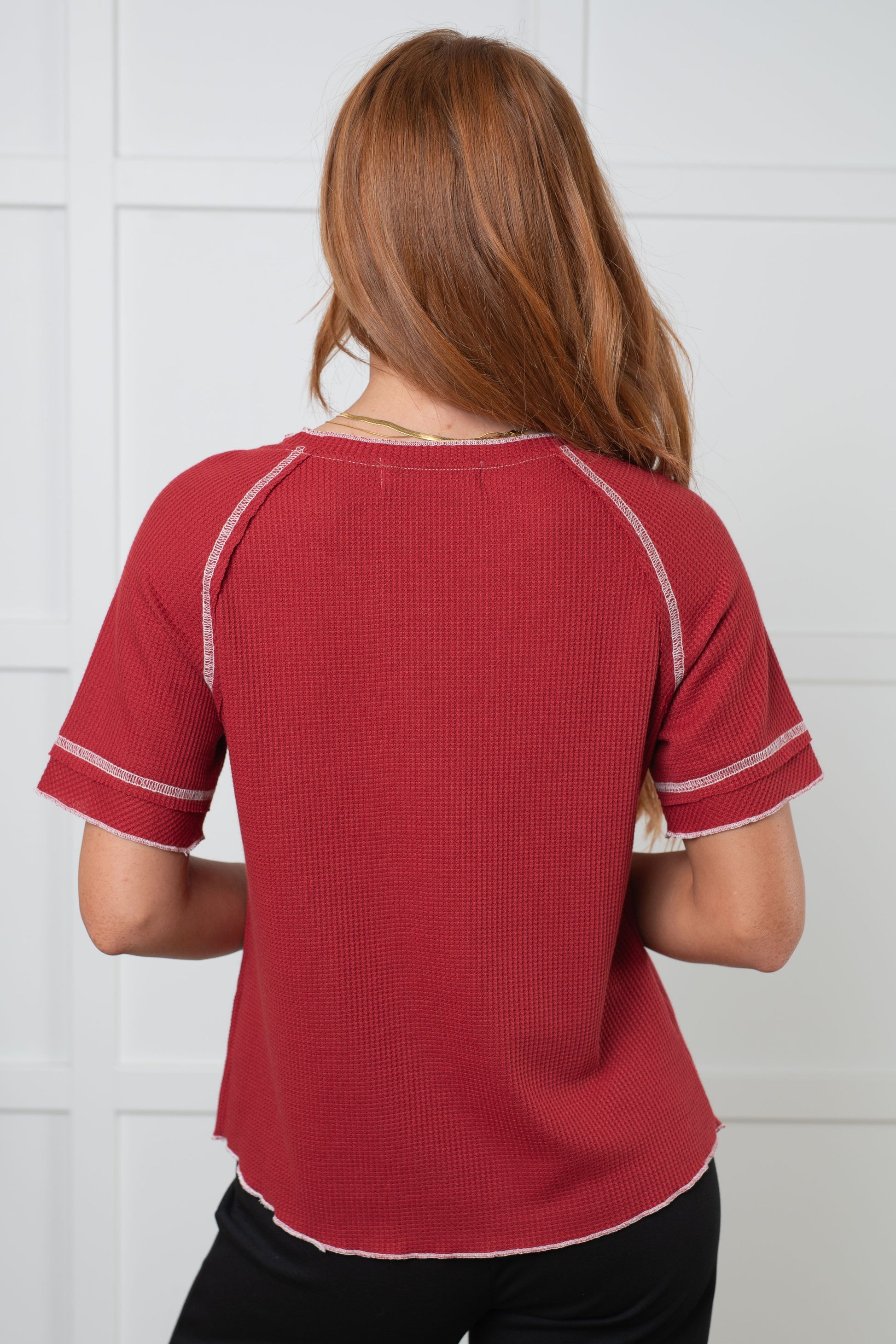 Waffle Knit Tee in Cranberry with round neckline, short raglan sleeves, and raw edge accents.