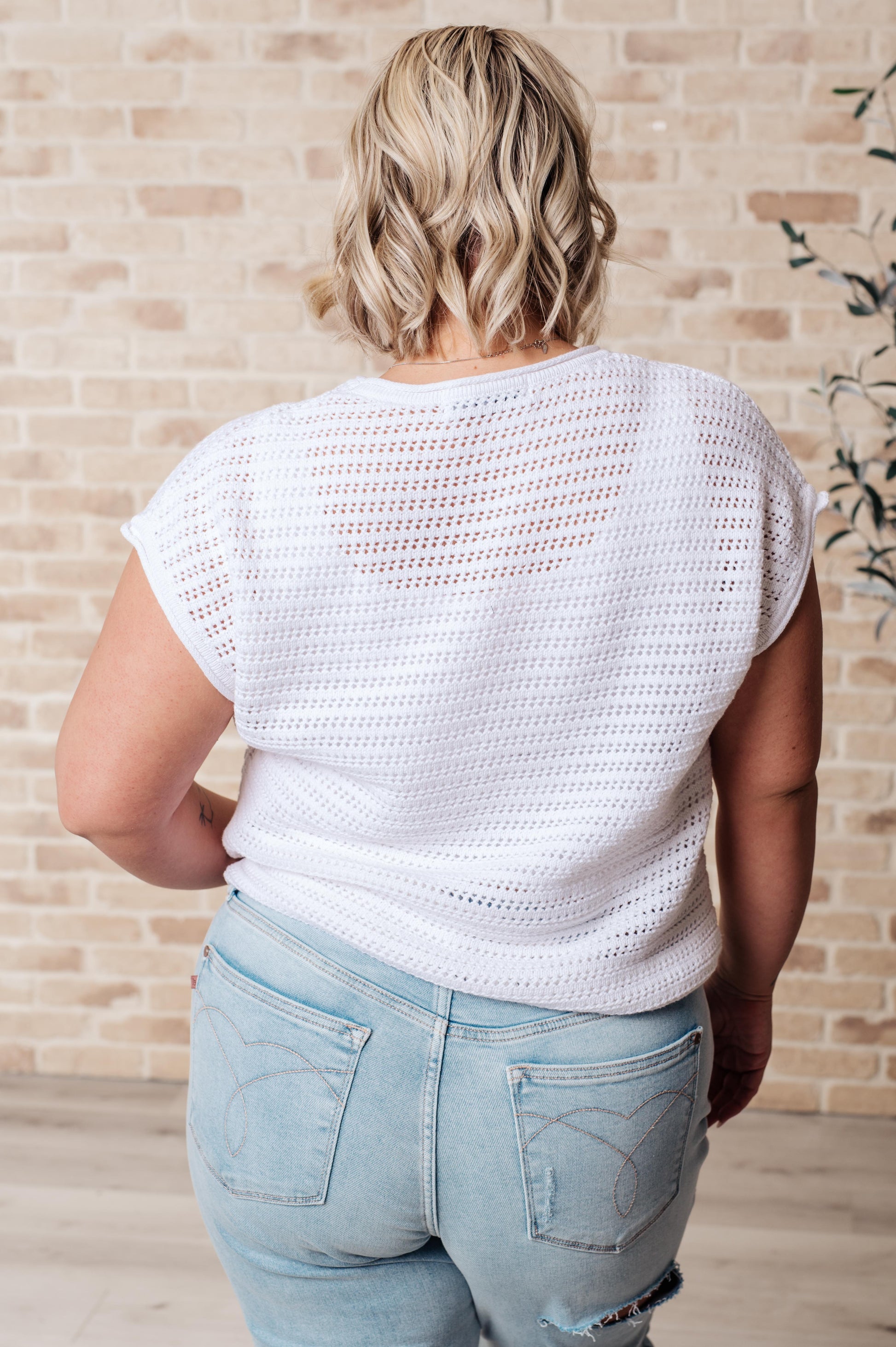 Back view of plus size white Callie Open Knit Sweater, airy knit with ribbed cuffs and dolman sleeves for casual style.
