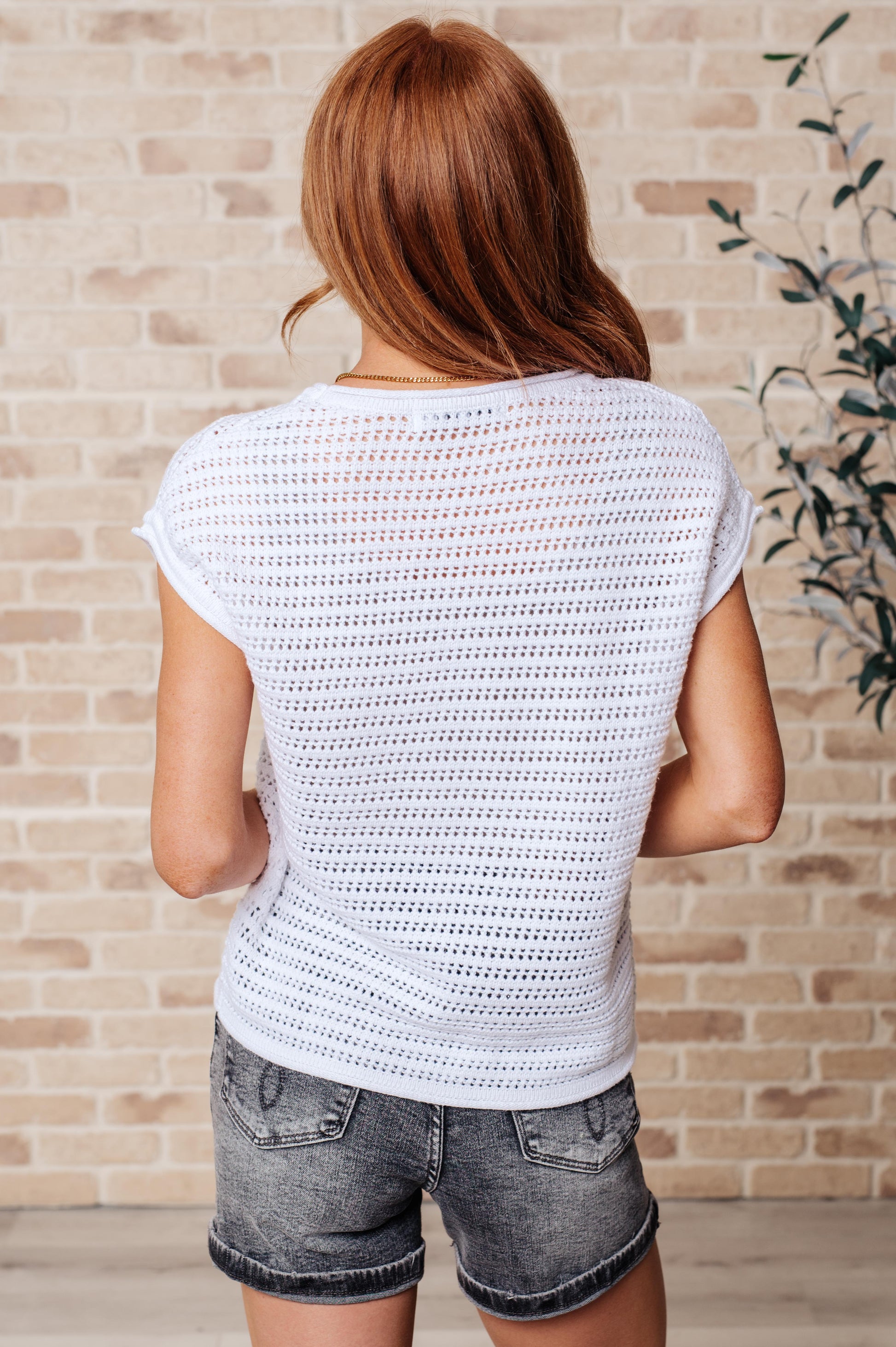 Back view of white Callie Open Knit Cap Sleeve Sweater, lightweight knit with ribbed cuffs and dolman sleeves for all-day comfort.